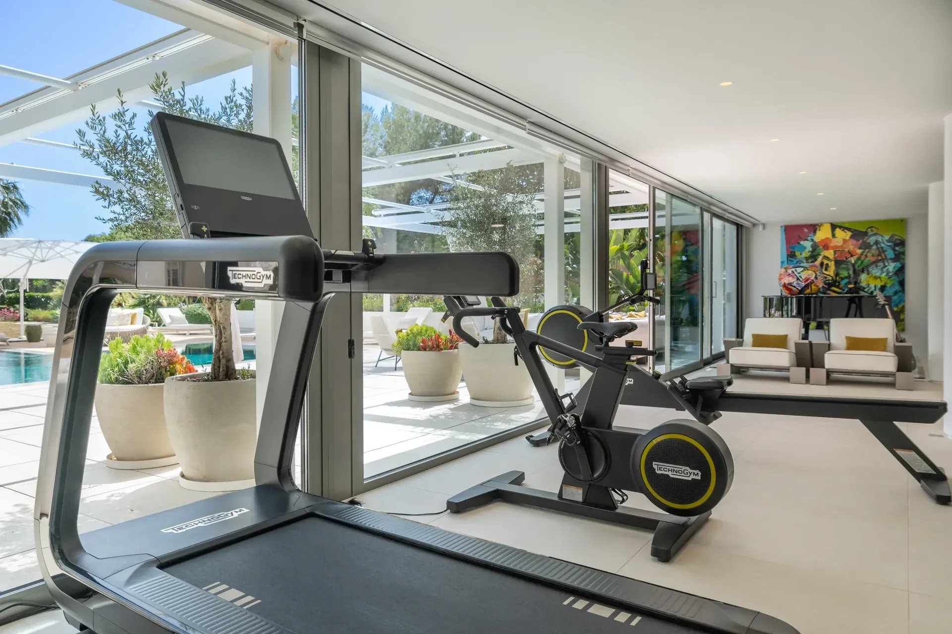 Modern fitness room at Villa Serenity overlooking the pool