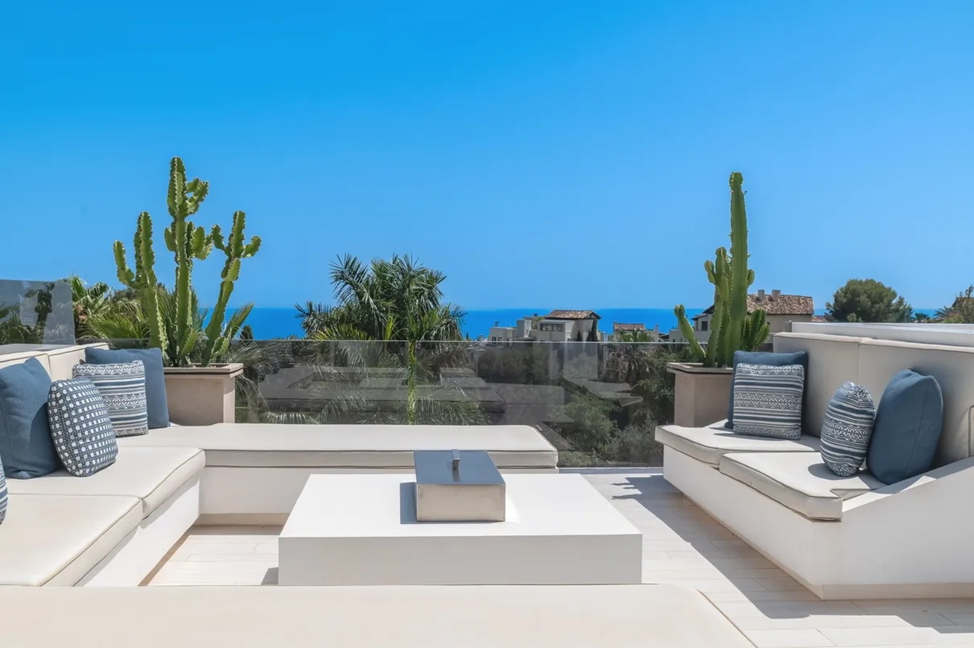 Stylish rooftop lounge with sofas and sea views at Villa Serenity