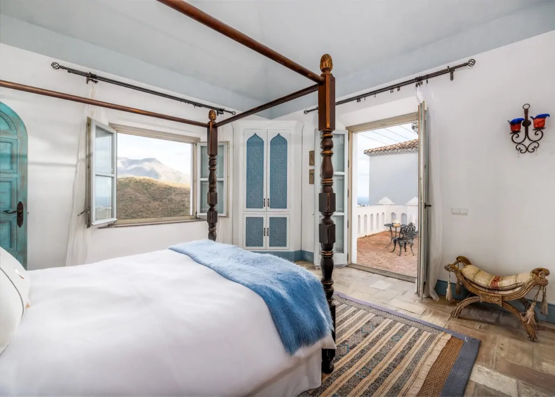 Four-poster bed in bright suite at Finca Santa Katerina