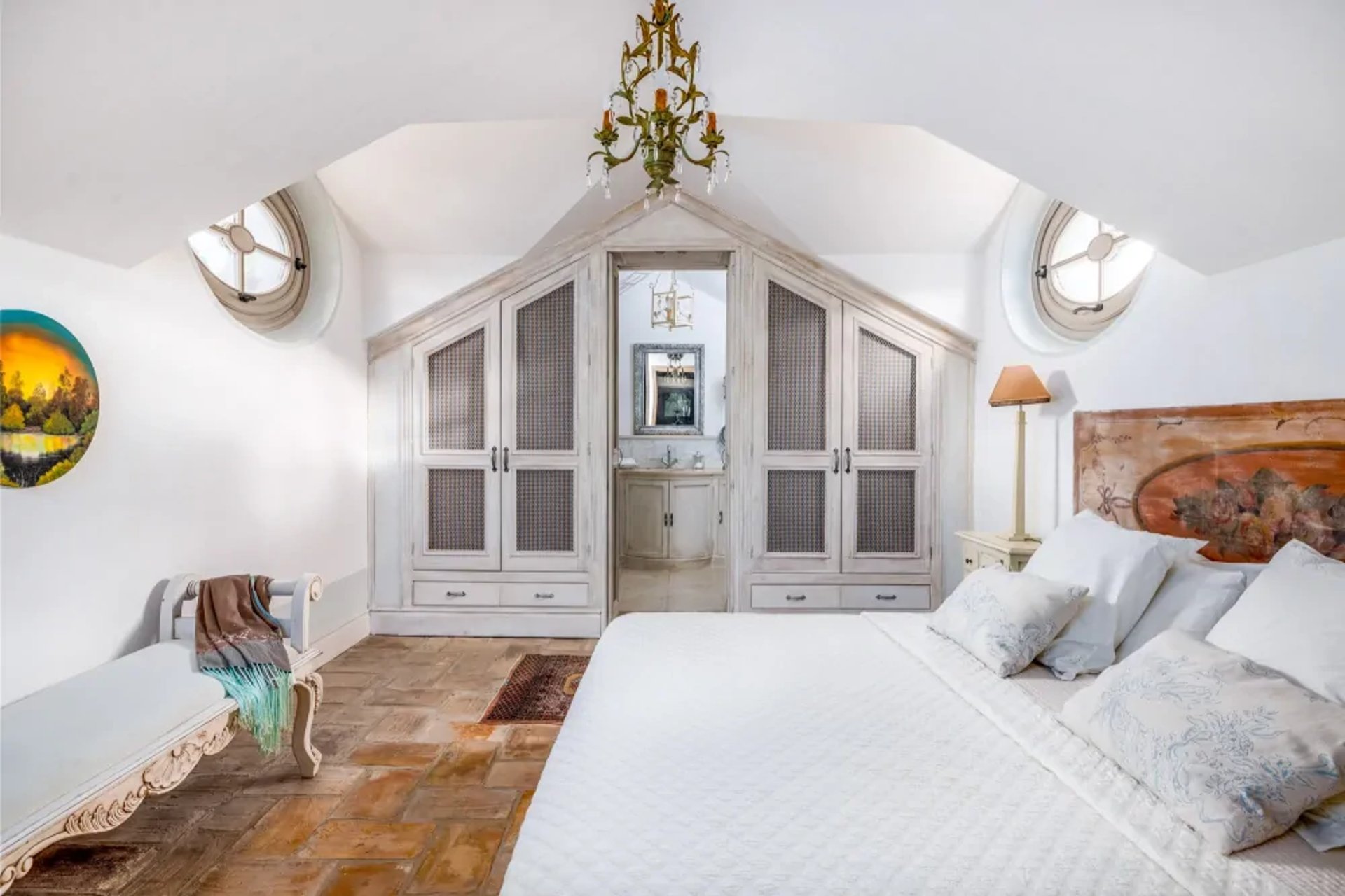 Attic-style bedroom with chandelier at Finca Santa Katerina