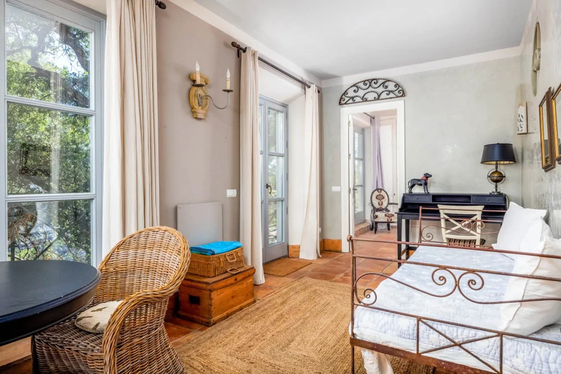 Bedroom with wicker chair and terrace view at Finca Santa Katerina