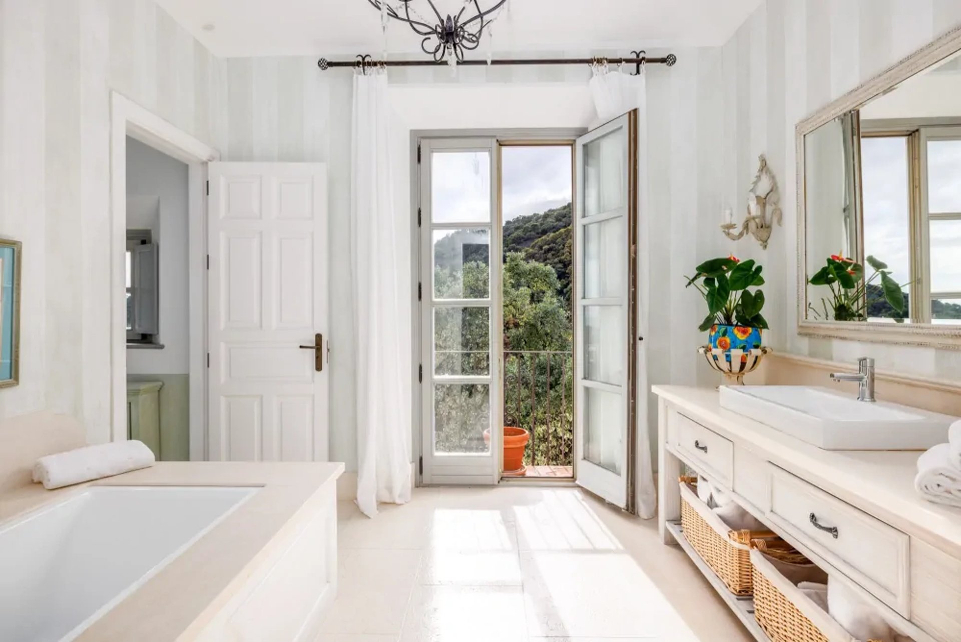 White bedroom with balcony access at Finca Santa Katerina