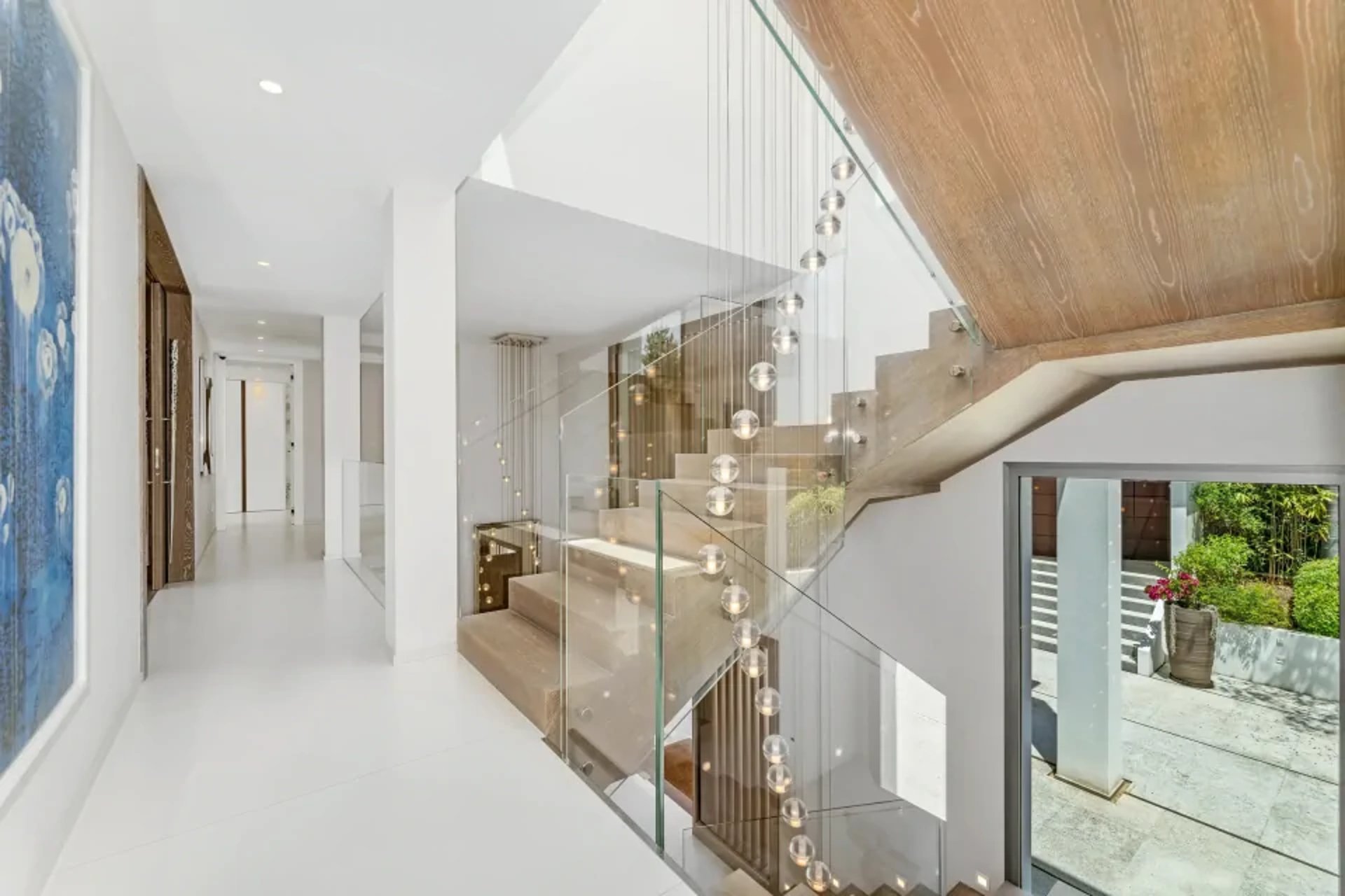 Villa Serenity hallway with staircase and modern artwork