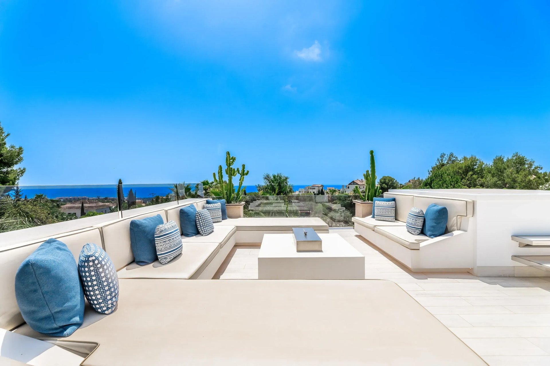 Stylish rooftop lounge with sofas and sea views at Villa Serenity