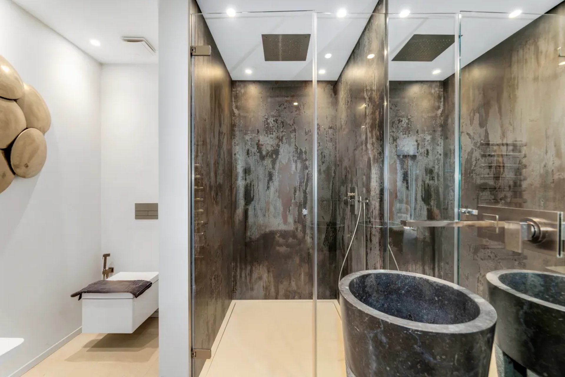 Modern double shower in dark stone at Villa Serenity