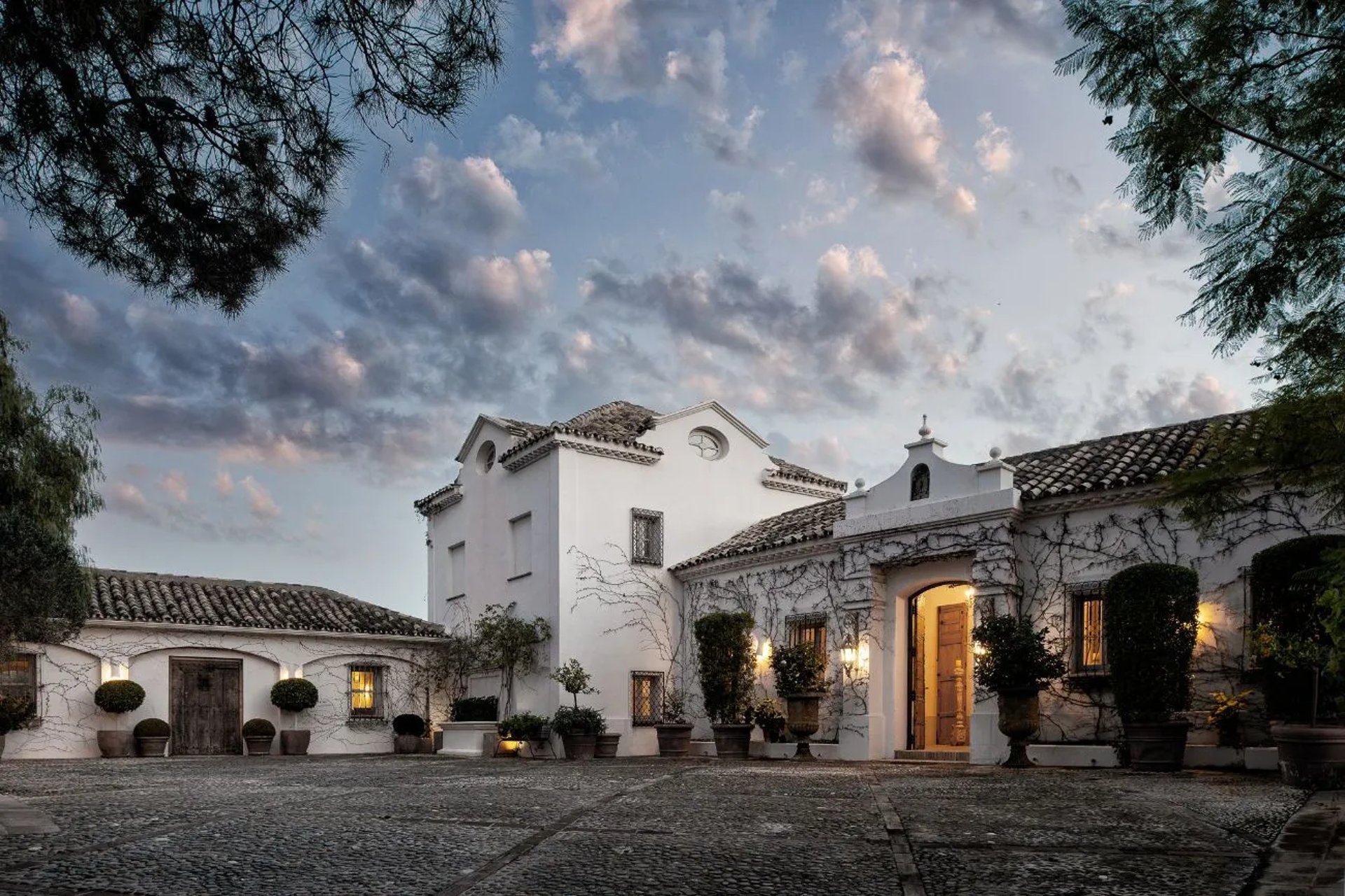 Finca Santa Katerina facade lit at dusk with courtyard view