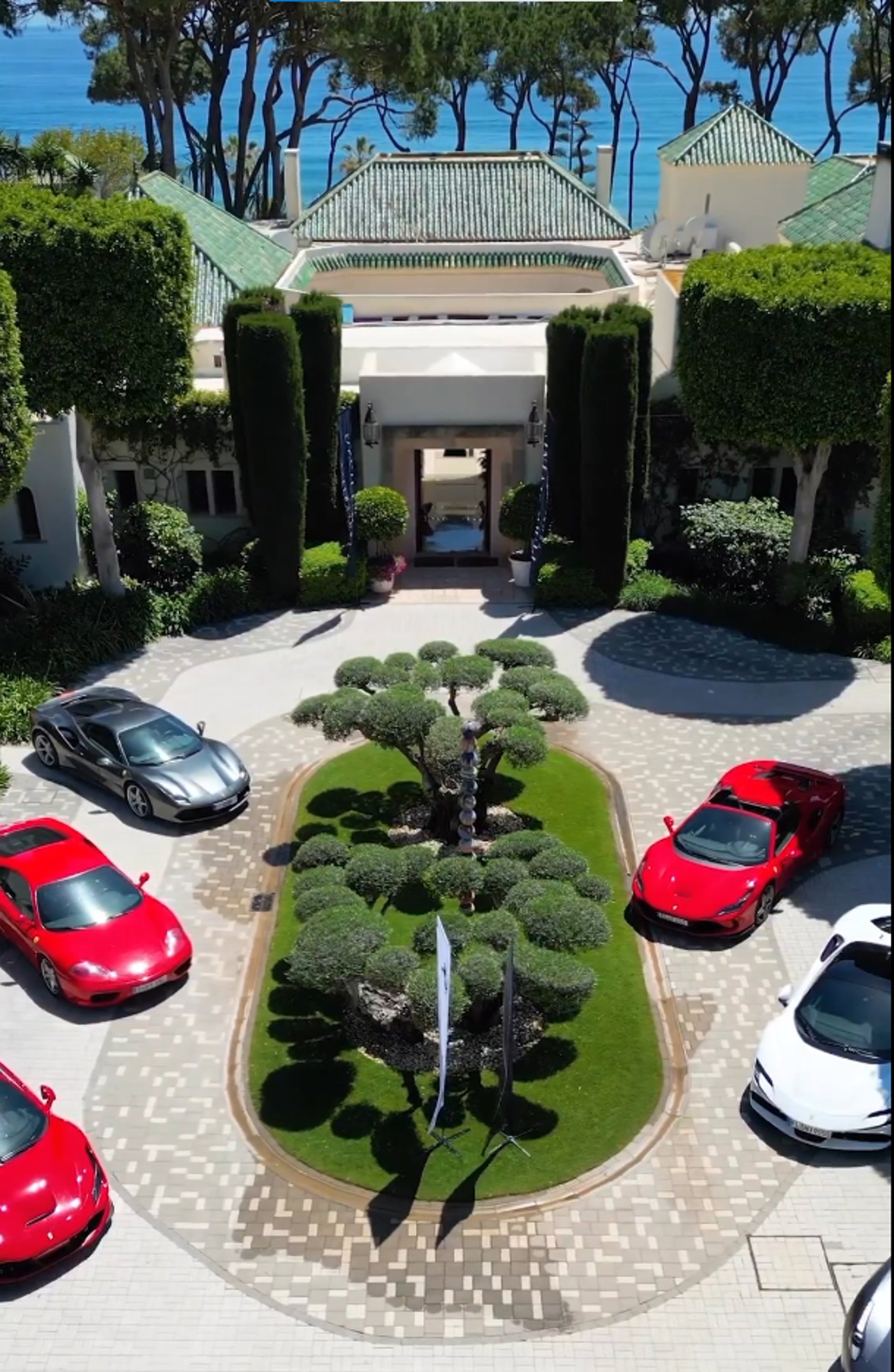 Corporate event at Villa El Rincon featuring luxury sports cars displayed in the courtyard