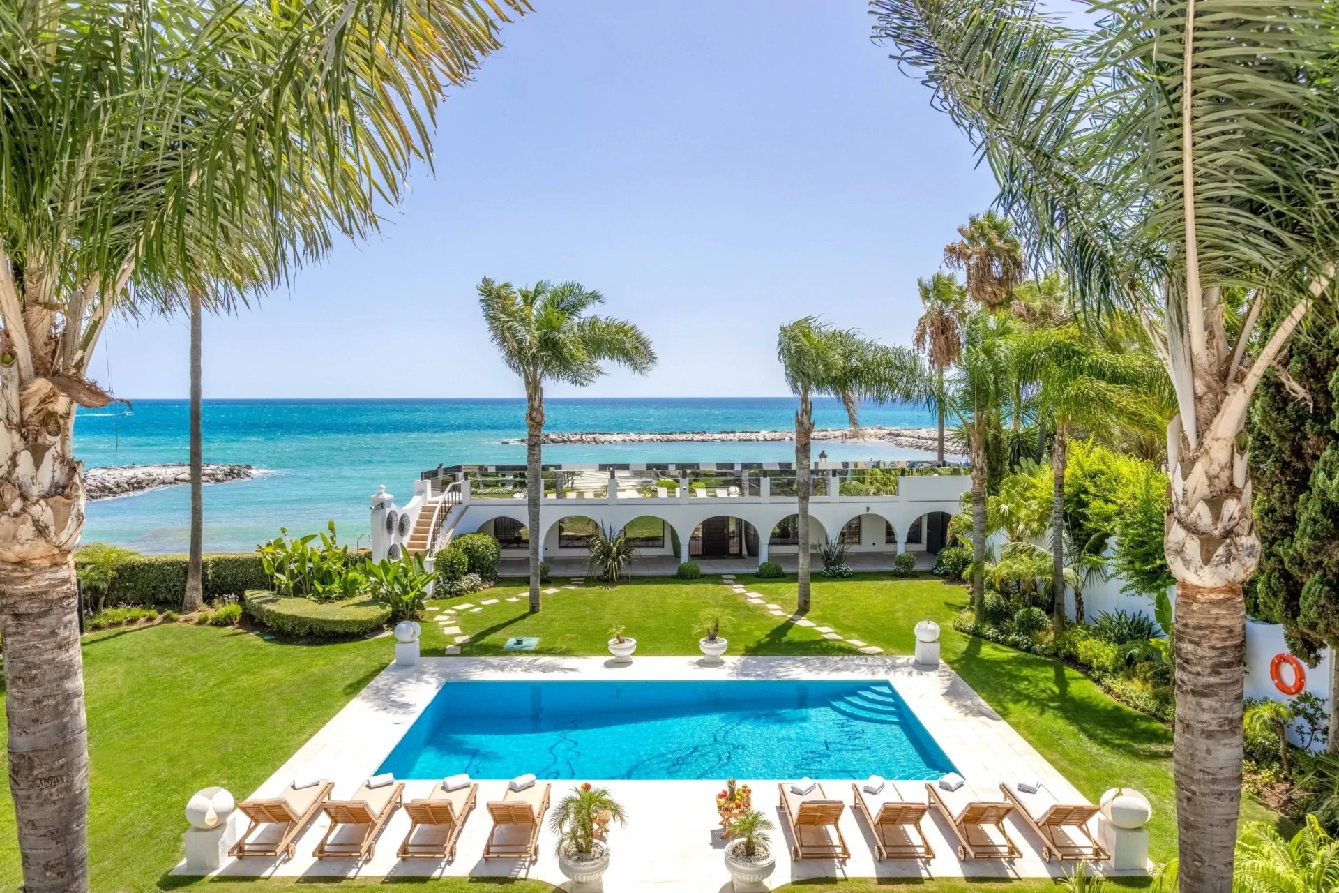 Beachfront garden and pool area in luxury villa Marbella near Puerto Banus