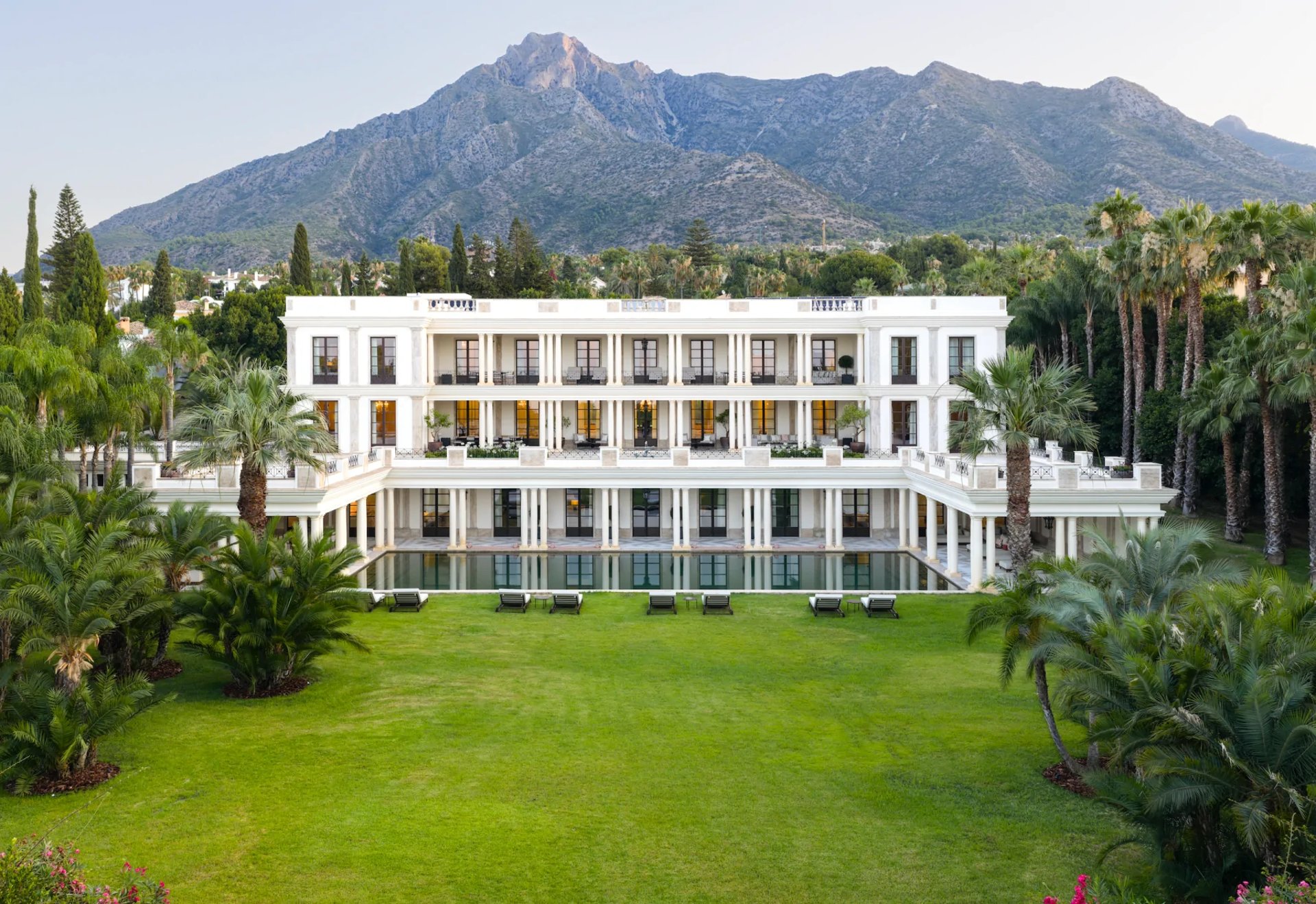 Villa exterior with landscaped lawns and mountain views