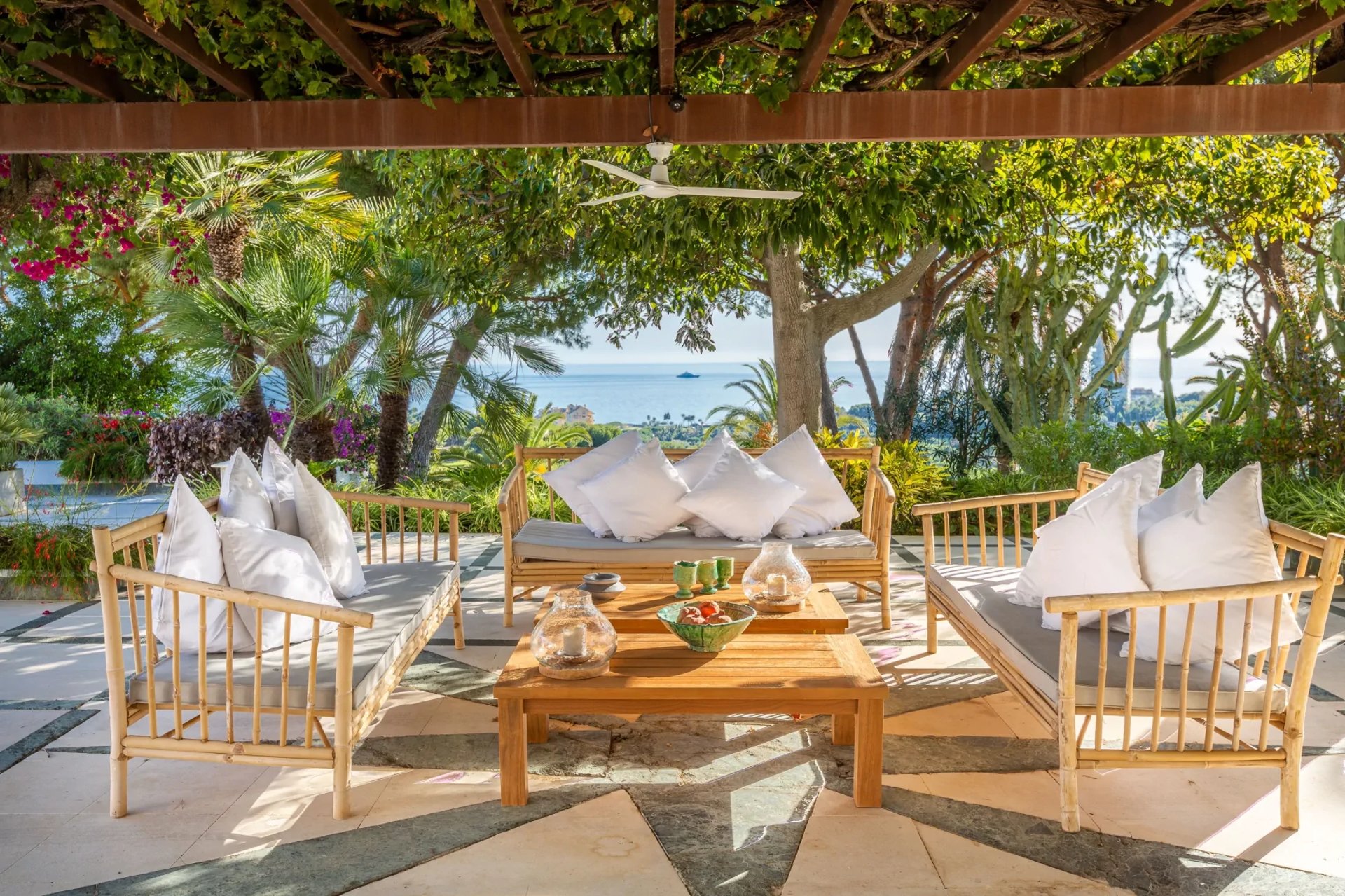 Covered terrace lounge with sea views and outdoor seating