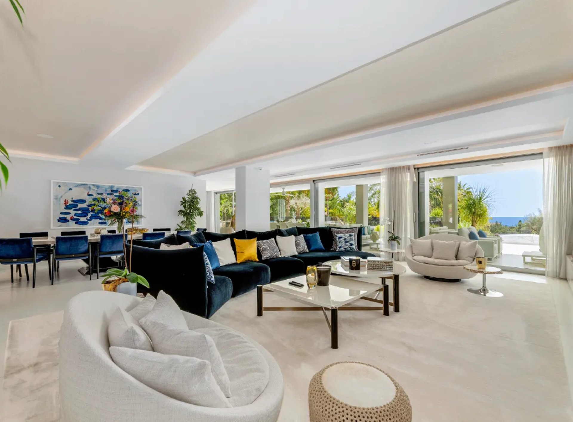 Spacious living room with art and terrace at Villa Serenity