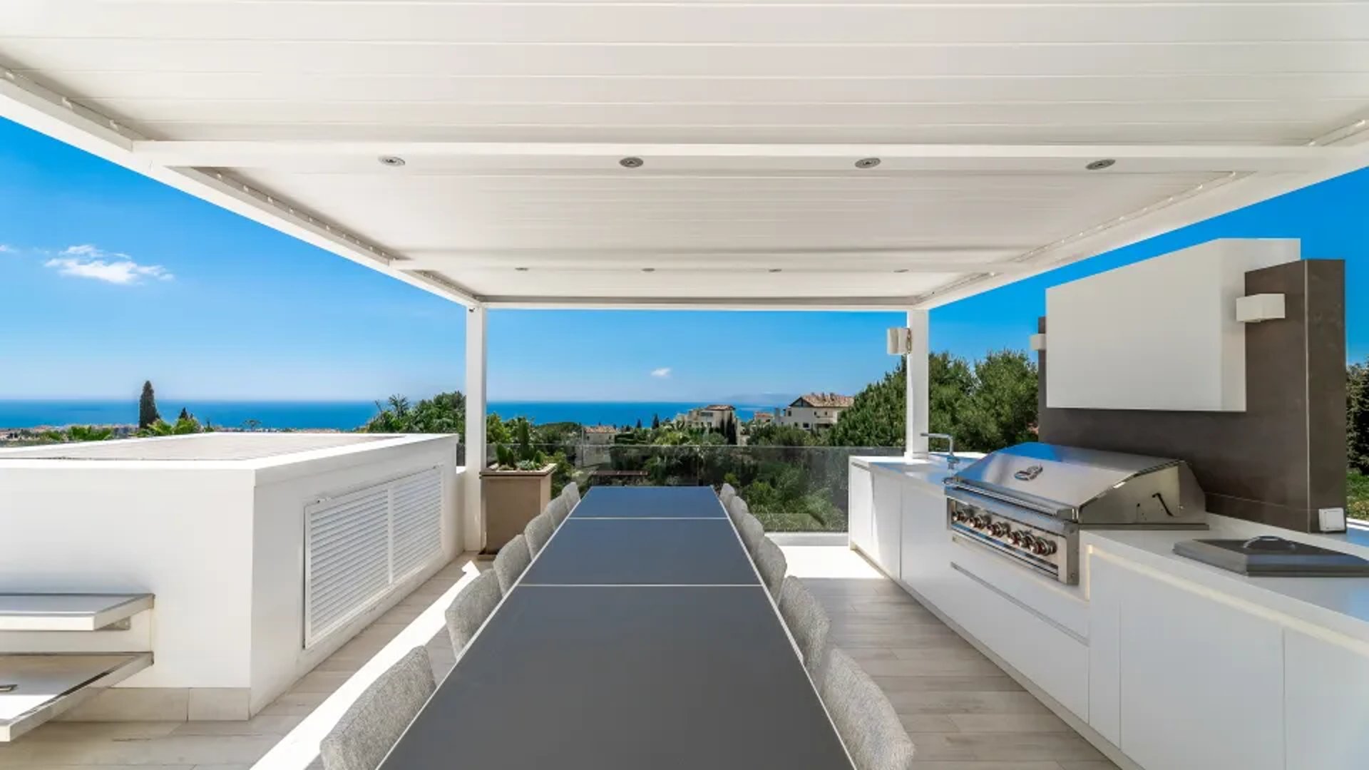 Rooftop dining terrace with ocean backdrop at Villa Serenity