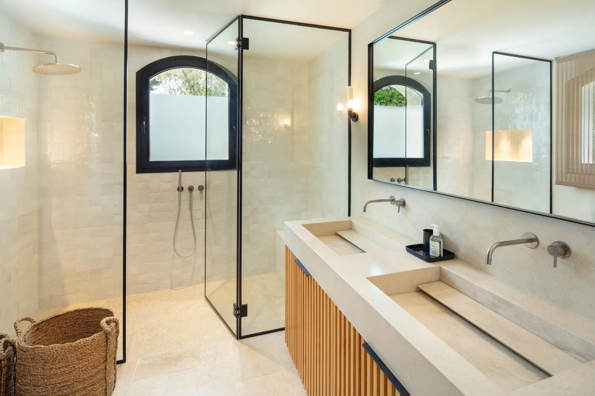 Marble bathroom at Villa La Gratitud with arched windows and double vanity
