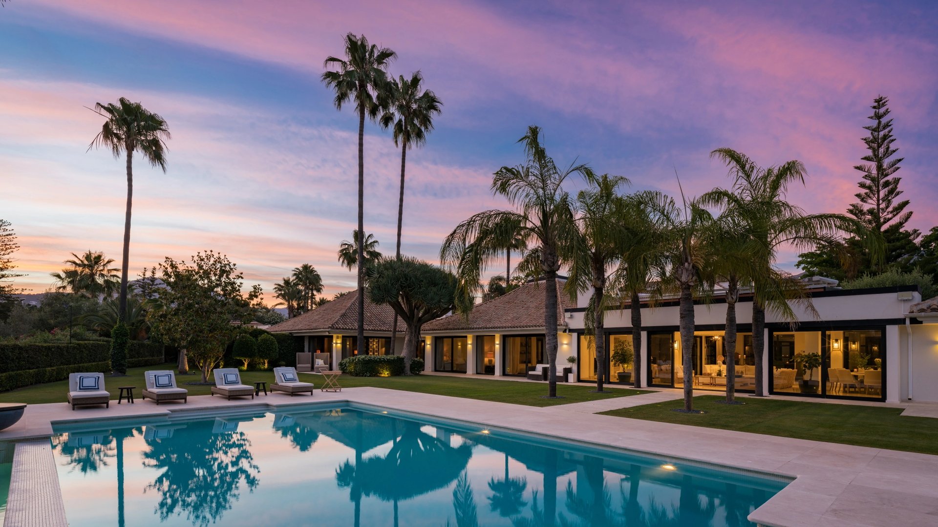 Entrance to Villa La Gratitud with wooden gates and lush surroundings