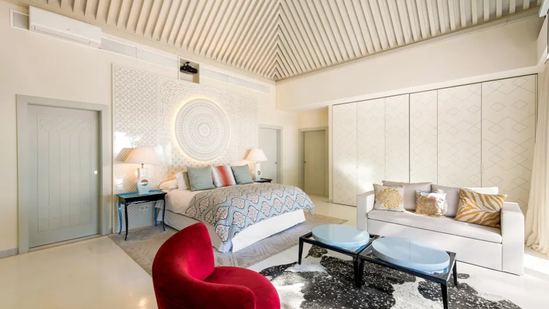 Chic suite at Villa El Rincon with armchair and red accents