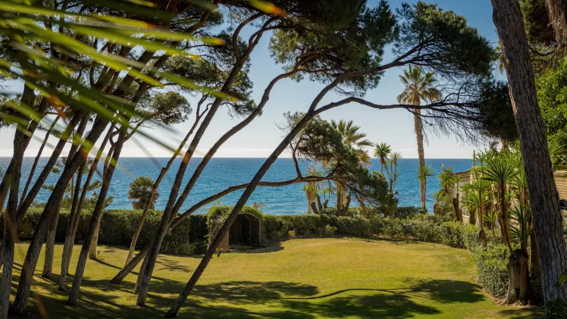 Garden and sea view at Villa El Rincon with pine trees