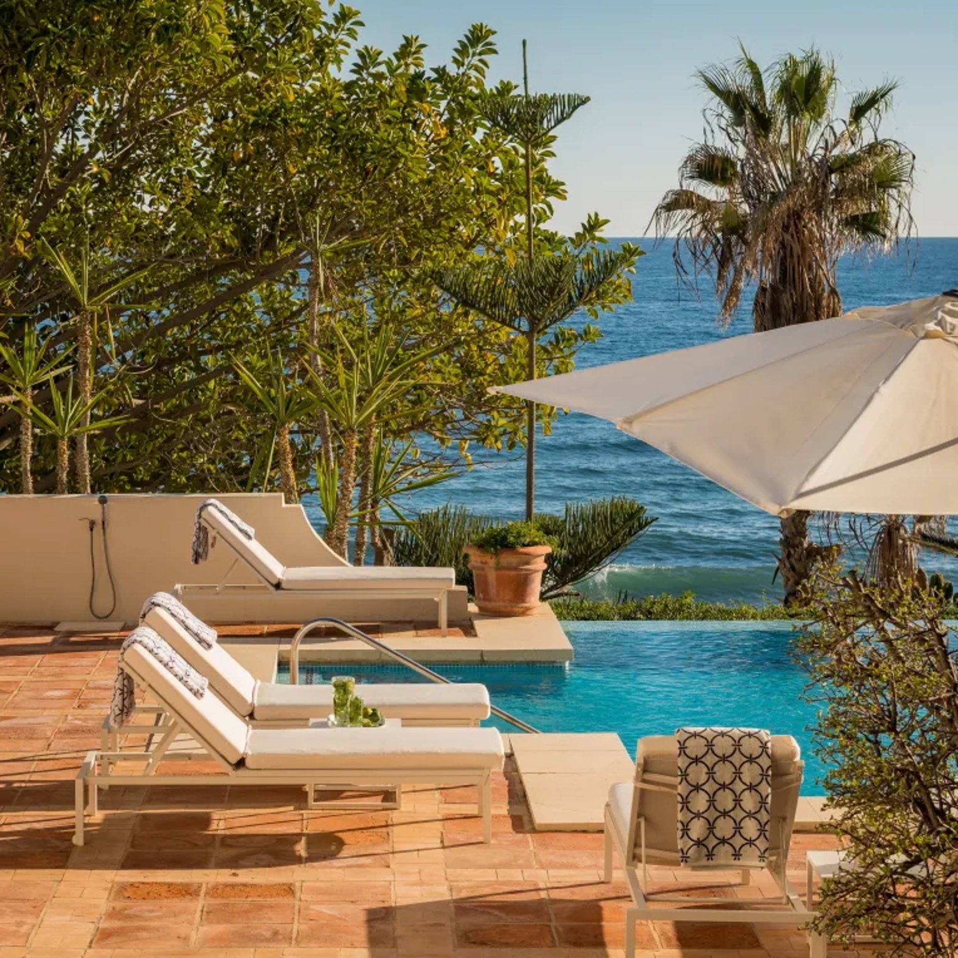 Pool terrace at Villa El Rincon with sunbeds and sea views