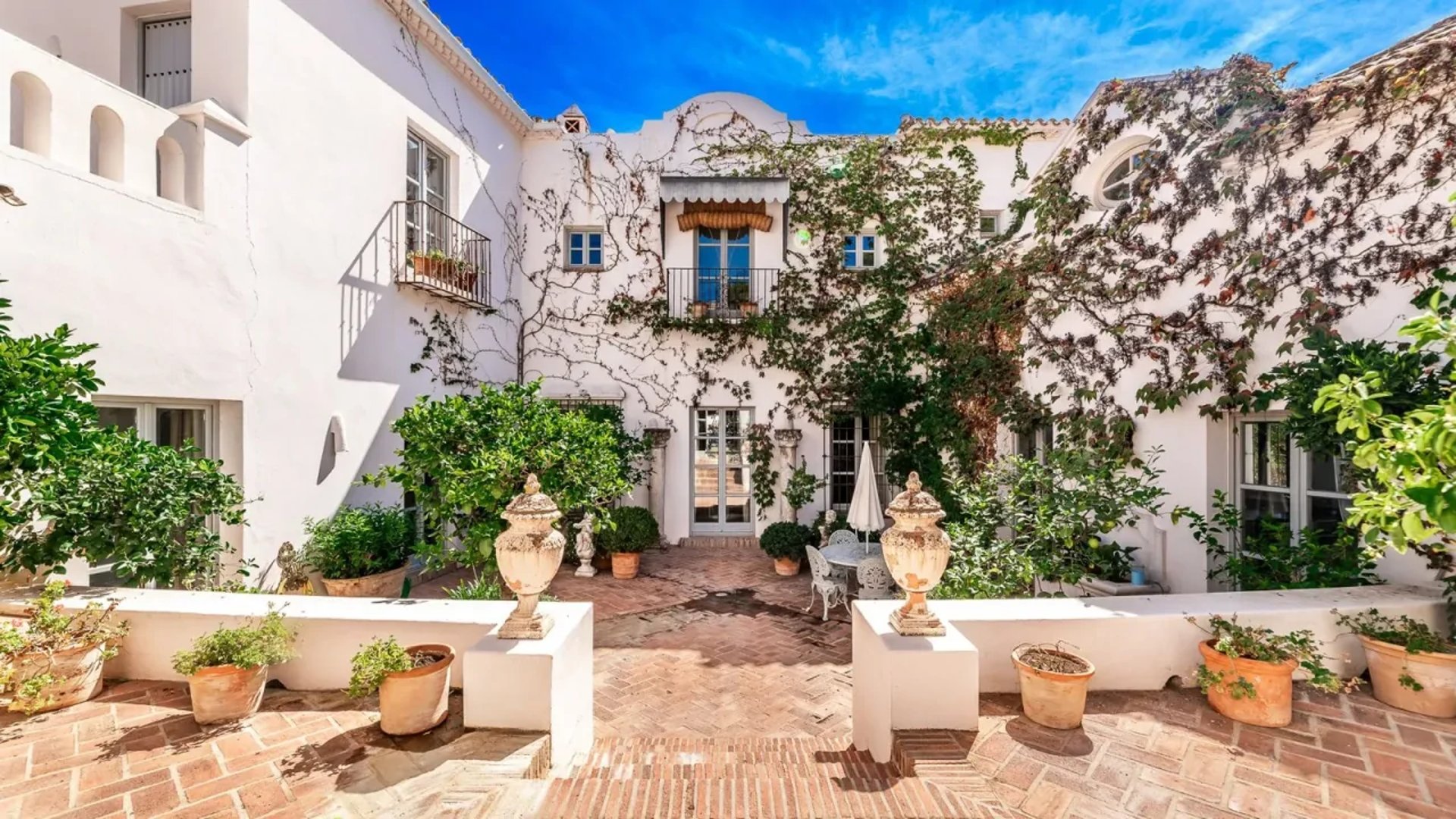 Courtyard with statues and blooming bougainvillea at Finca Santa Katerina