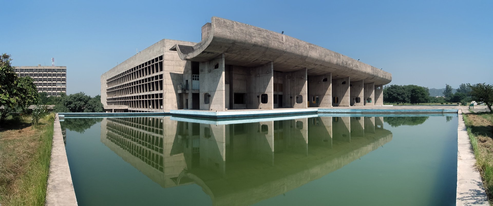 a large building sitting next to a body of water