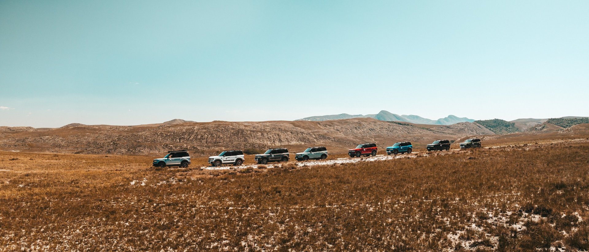 an abstract photo of a curved building with a blue sky in the background