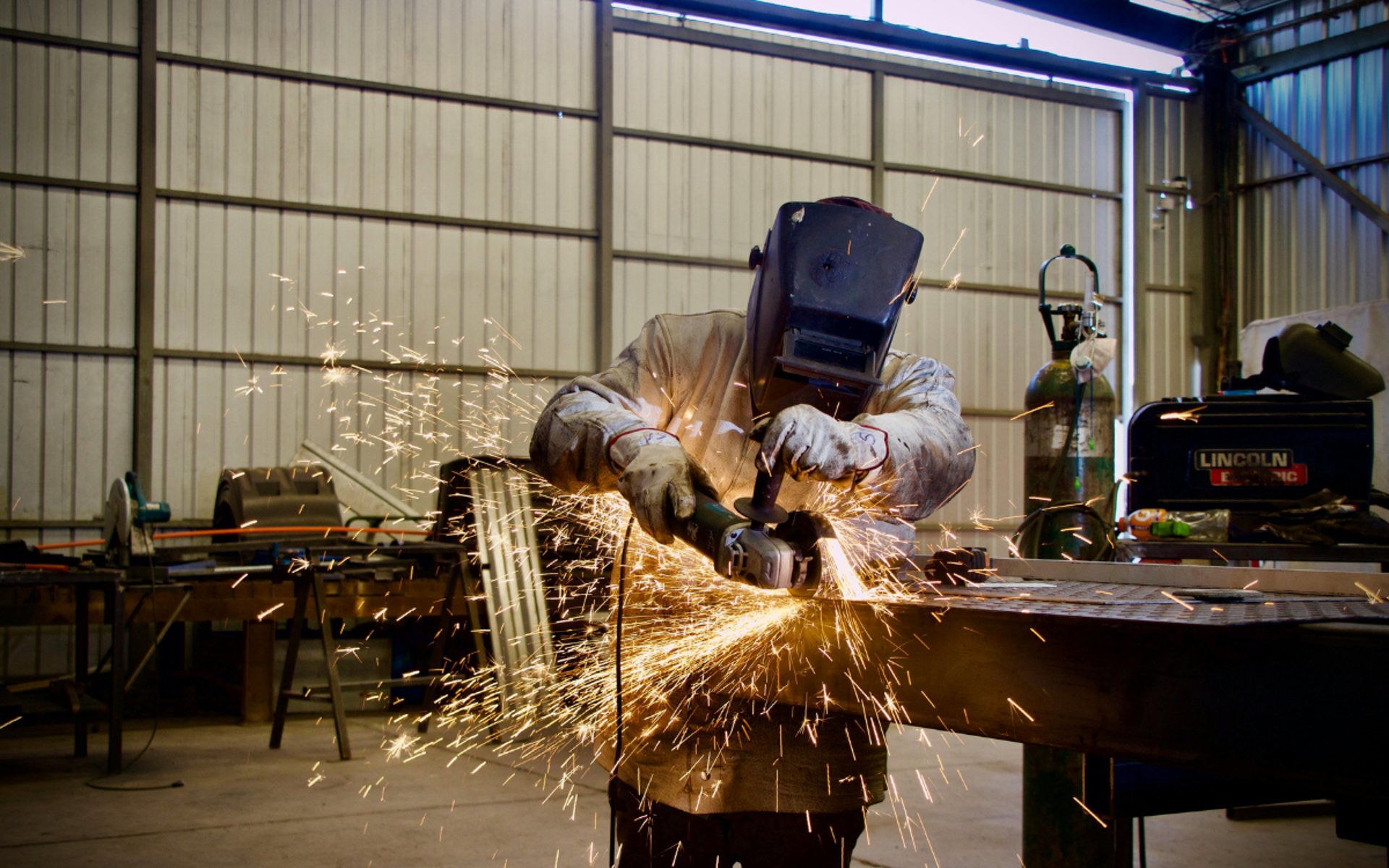 man welding a black metal