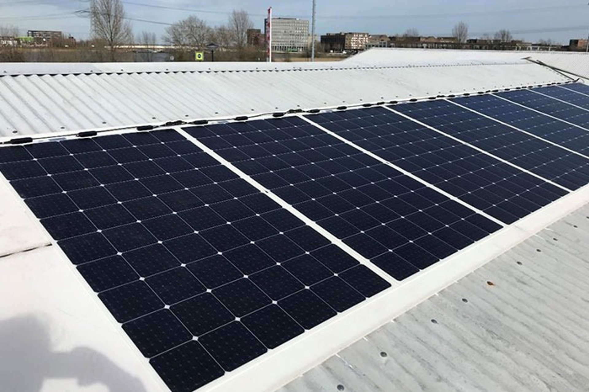 an abstract photo of a curved building with a blue sky in the background