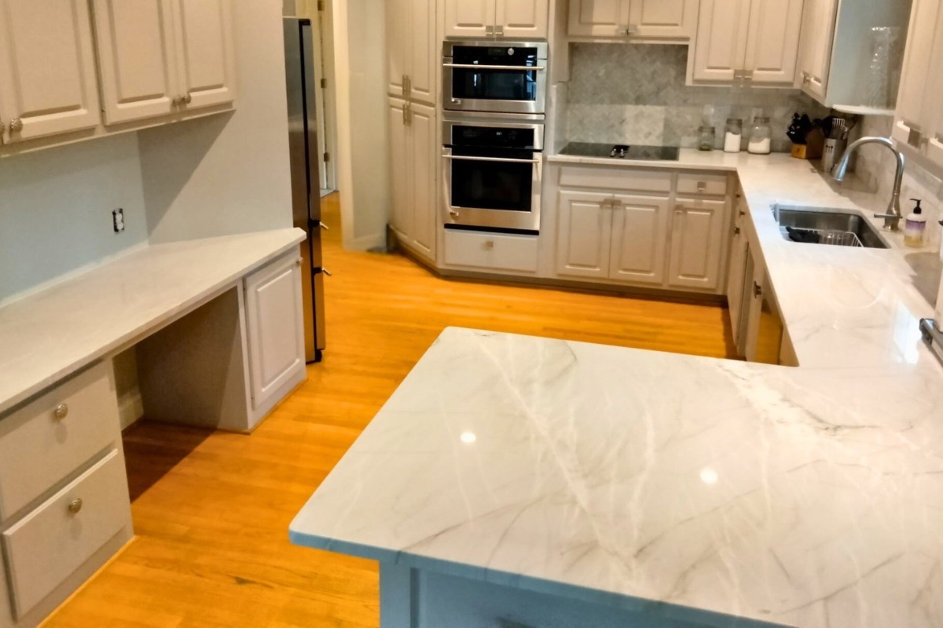 Modern kitchen with white cabinets and large island countertops