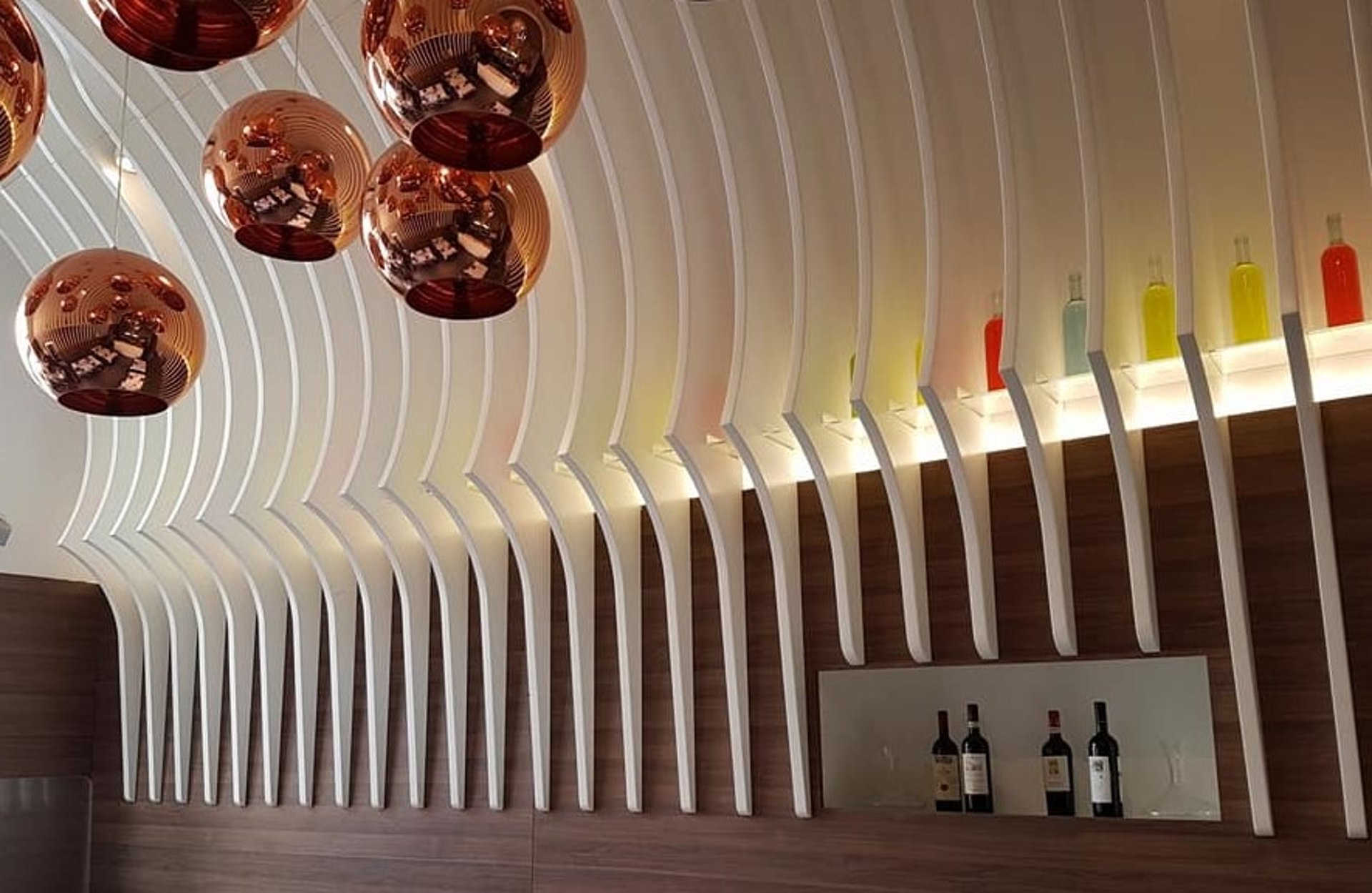 an abstract photo of a curved building with a blue sky in the background