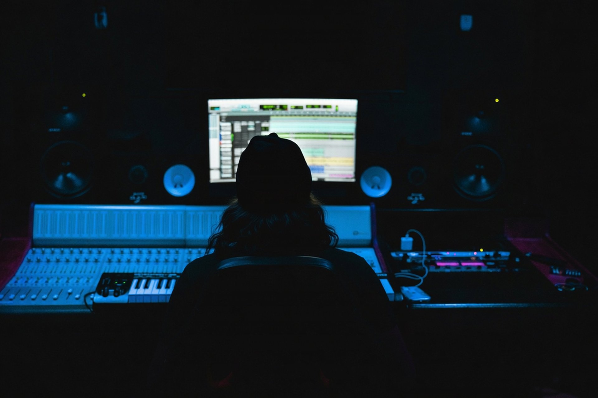 a man sitting in front of a computer in a dark room