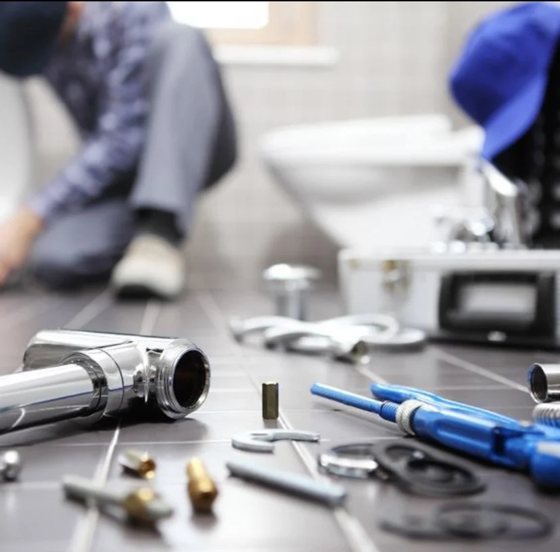 man wearing black pullover hoodie holding tool