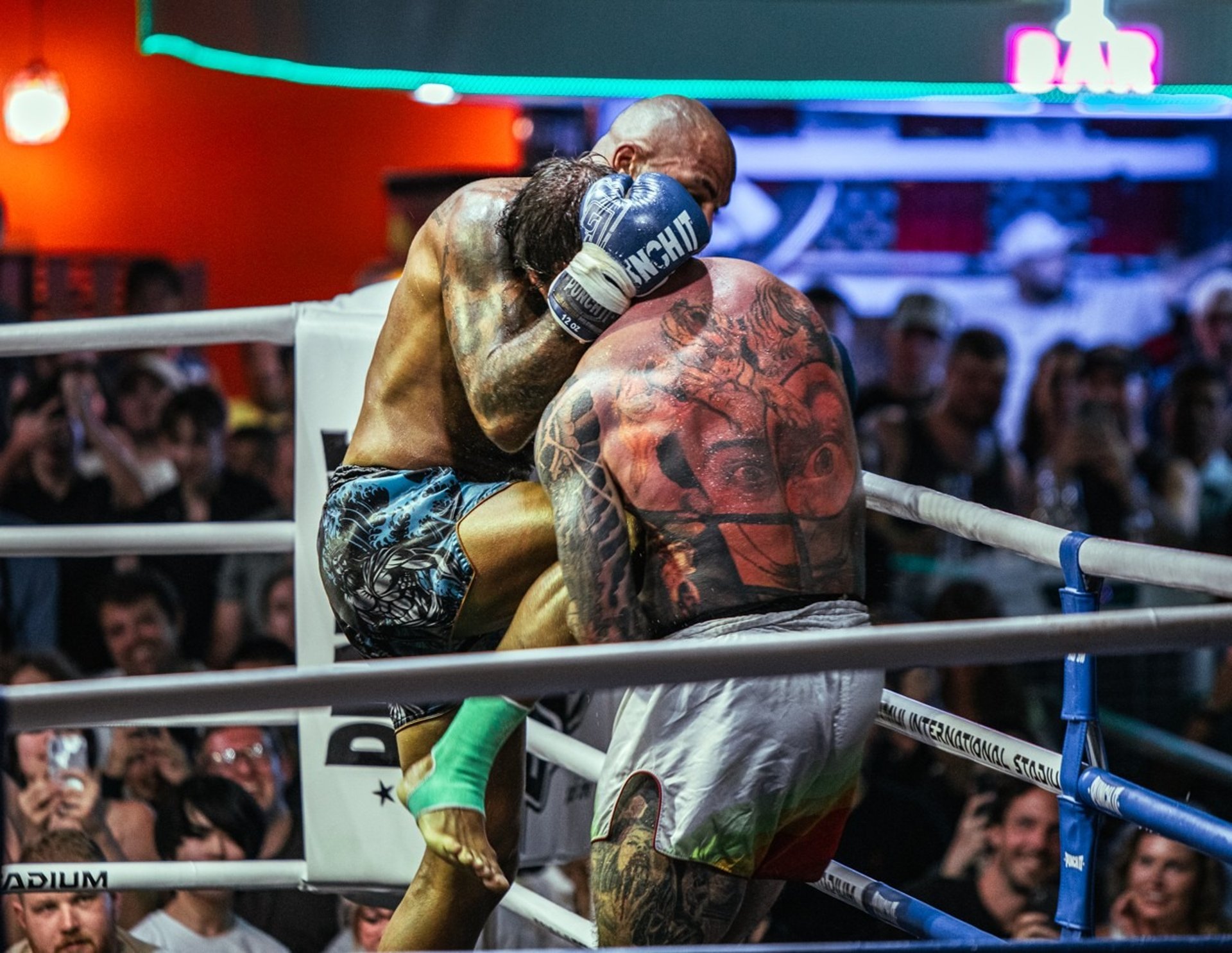 Muay thai fighter with people buy muay thai to watch Muay thai events