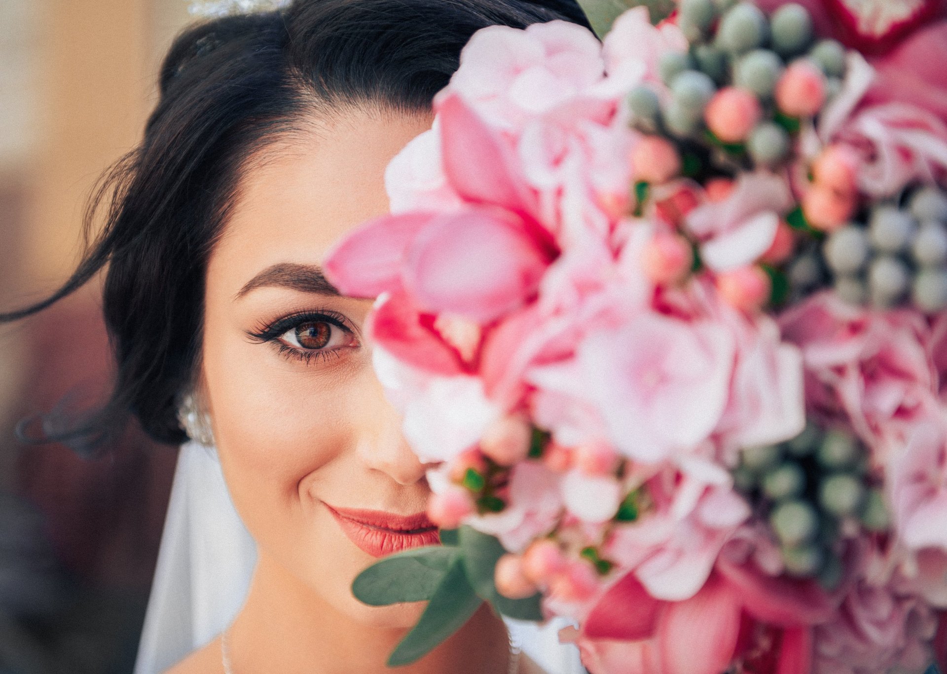 woman in white wedding dress standing near window during daytime