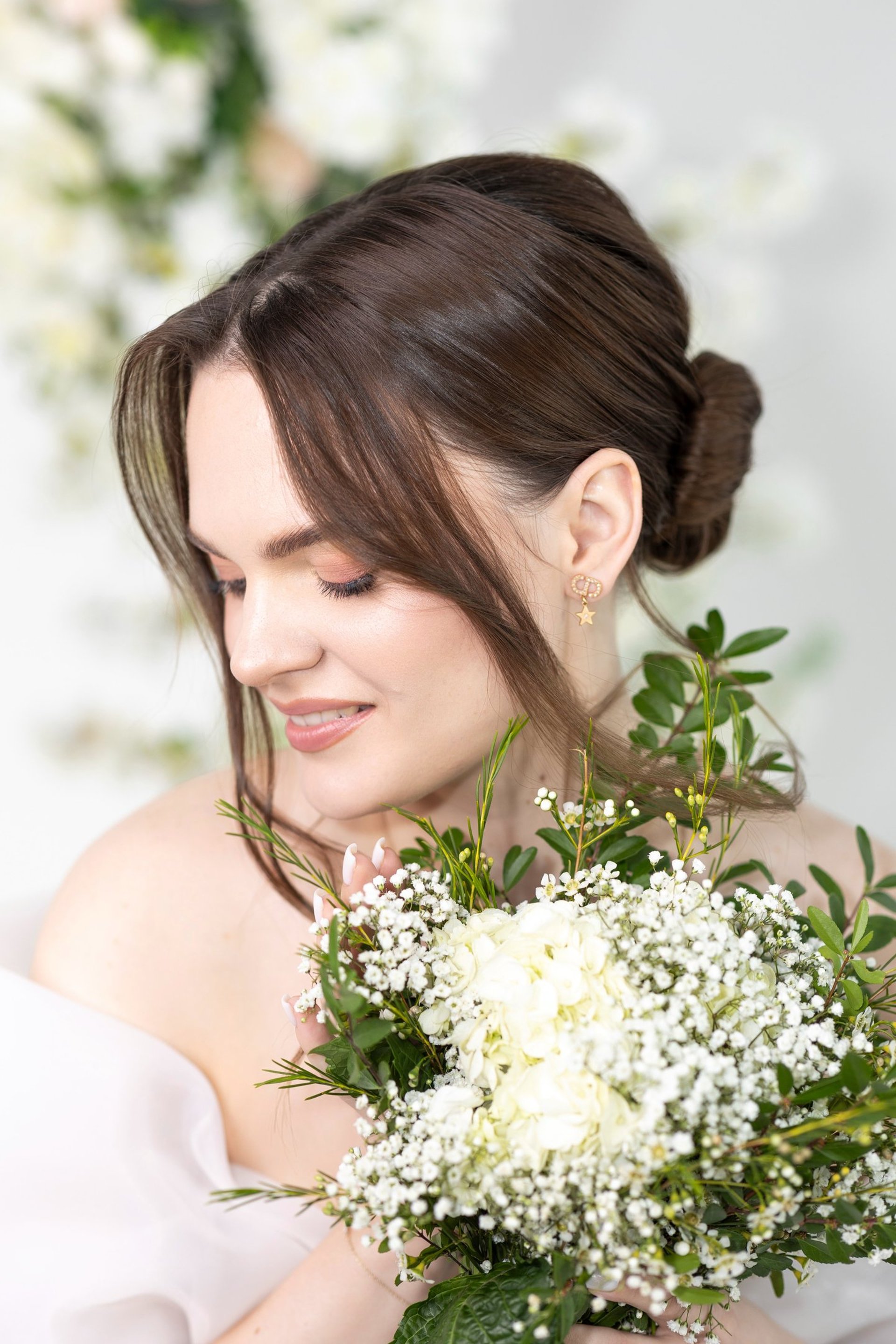 a woman in a white dress holding a bouquet of flowers