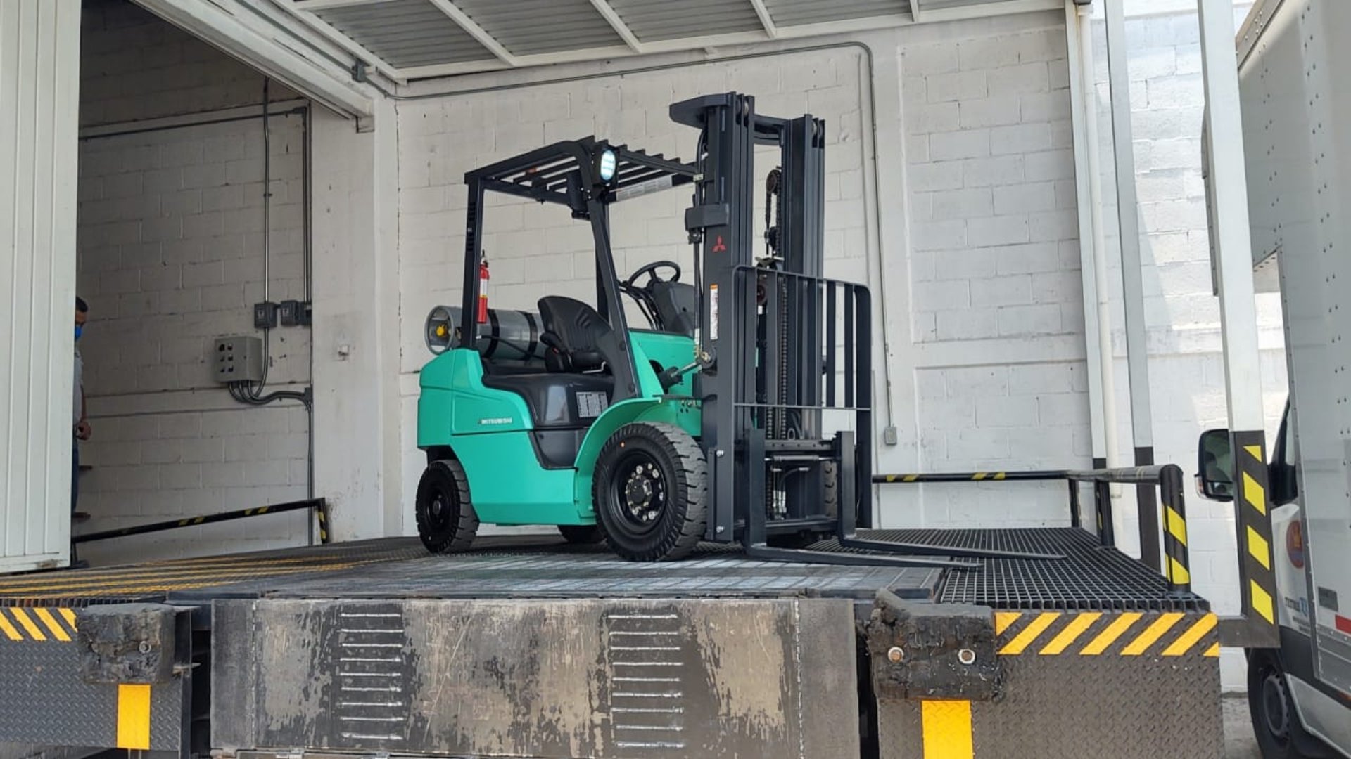 A forklift is parked in front of a building