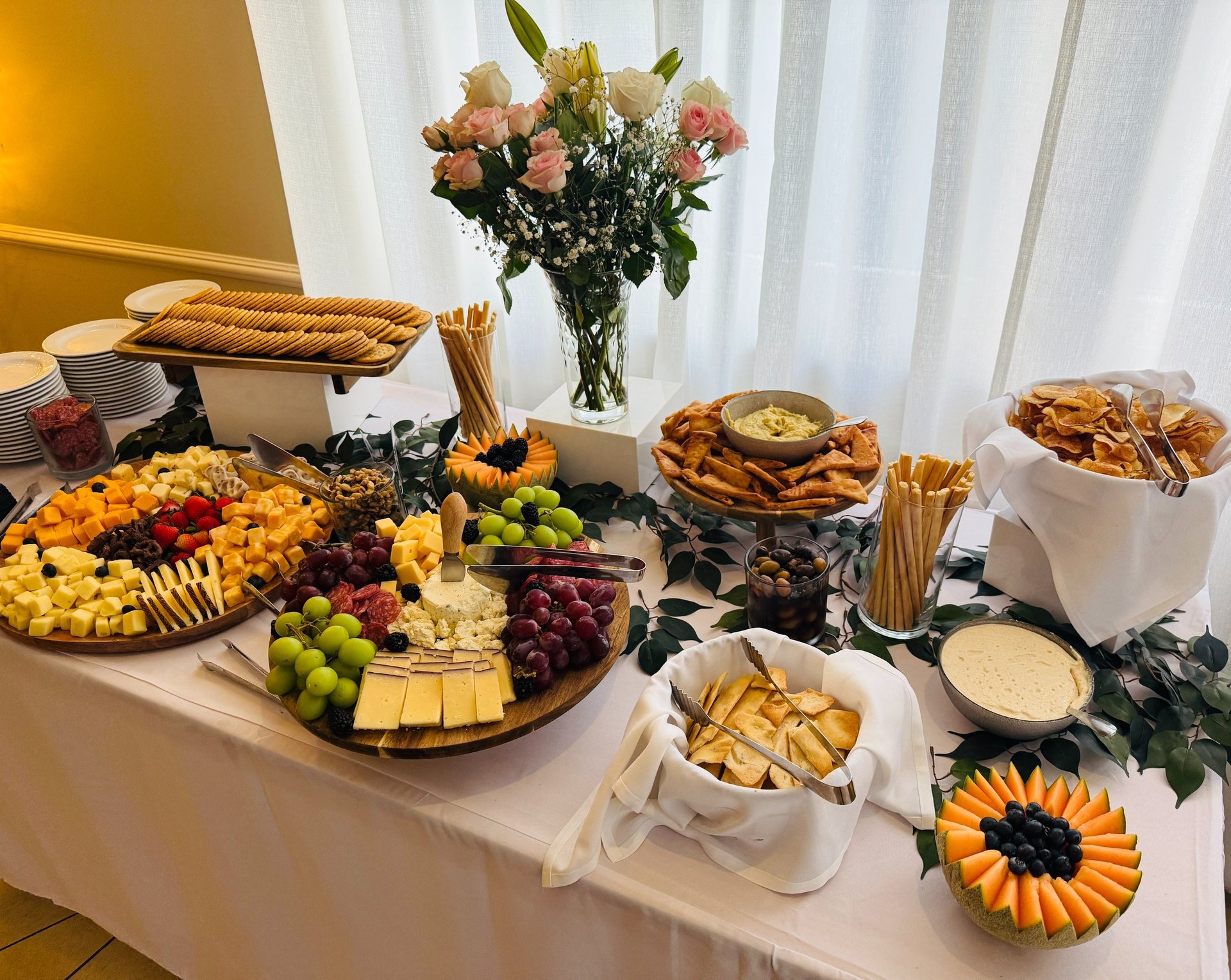 a wooden table topped with plates and glasses
