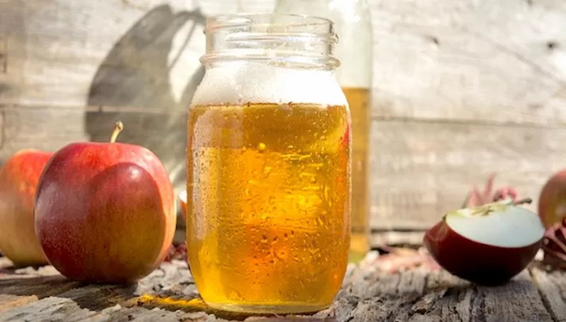 a glass of beer sitting on top of a table