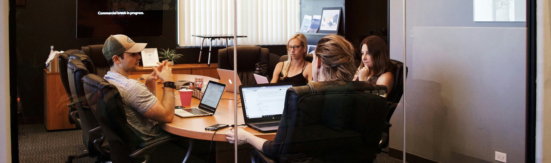 people sitting near table with laptop computer