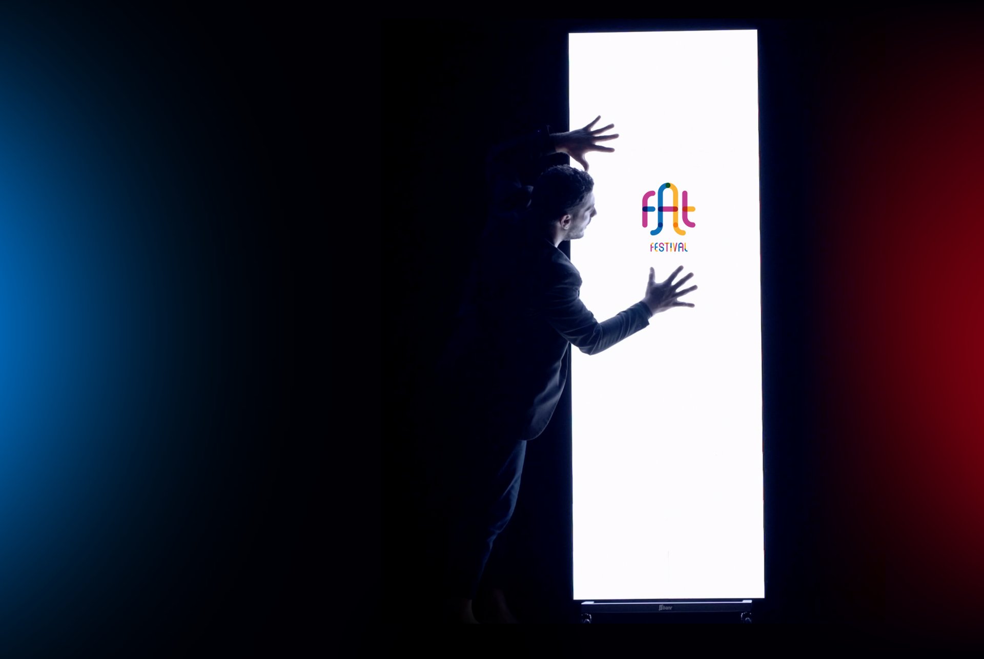 Speaker presenting on stage with audience watching