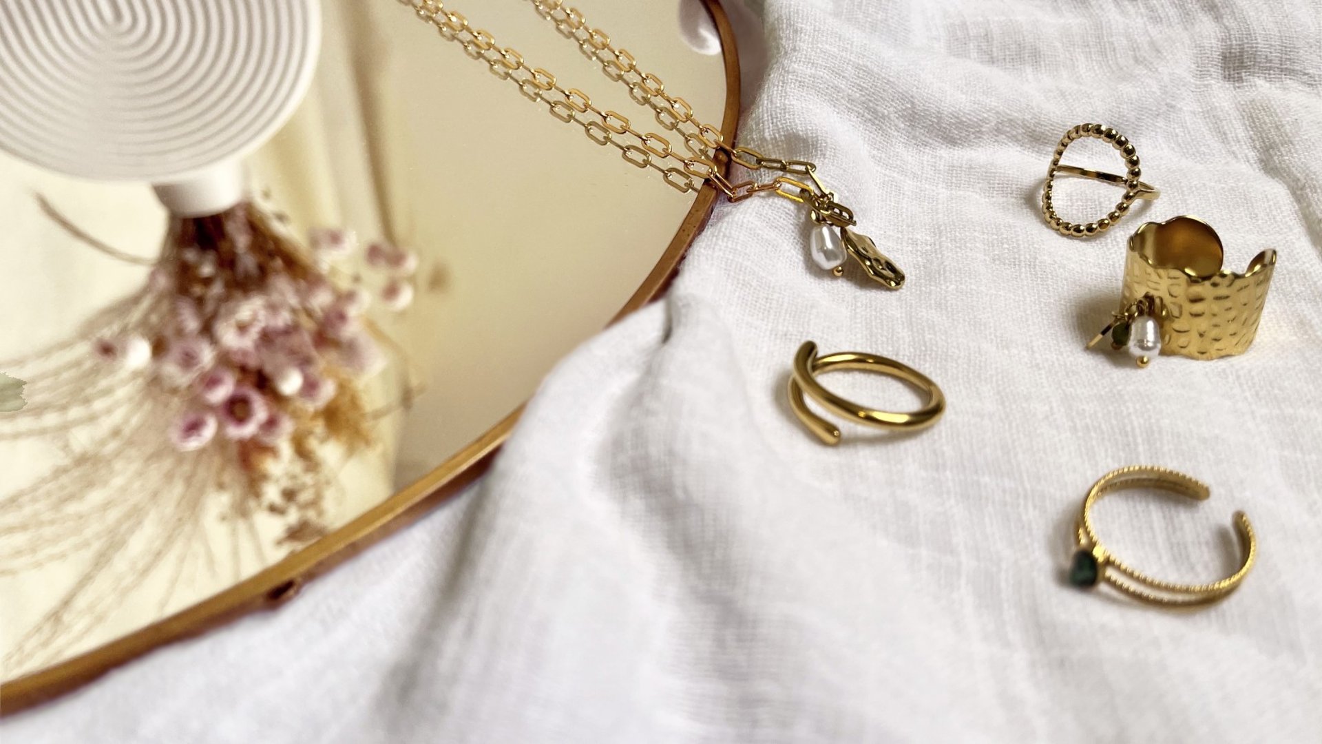 person wearing gold ring and gold ring