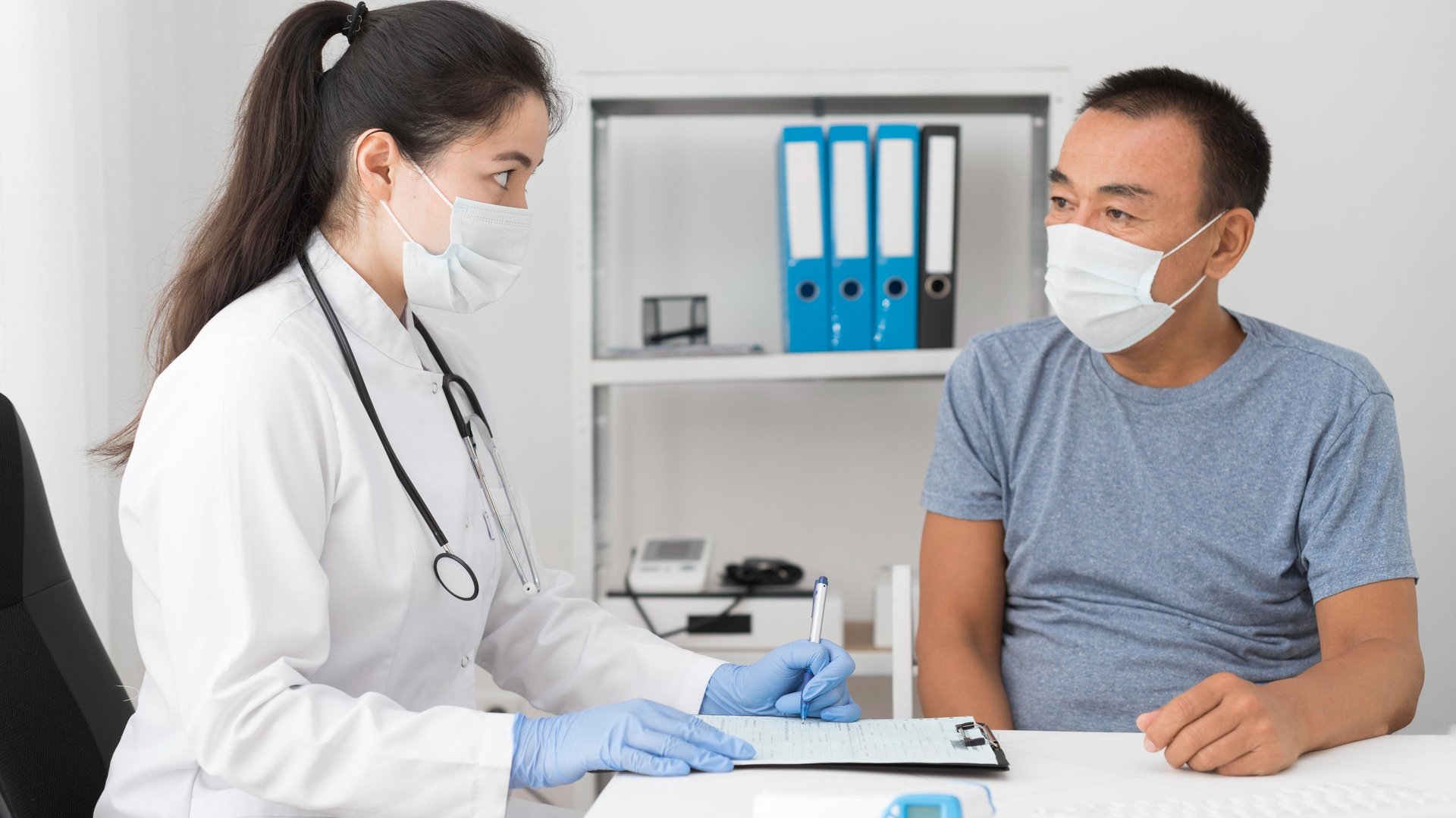 doctor holding red stethoscope