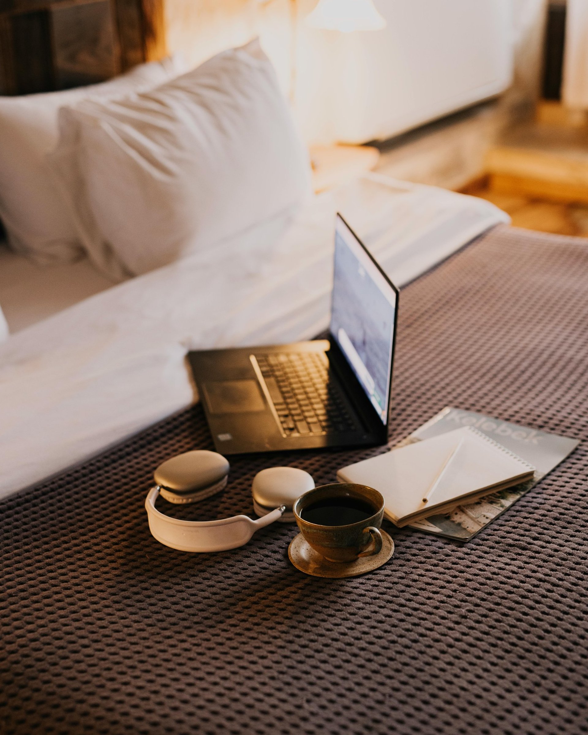 MacBook beside teacup with latte