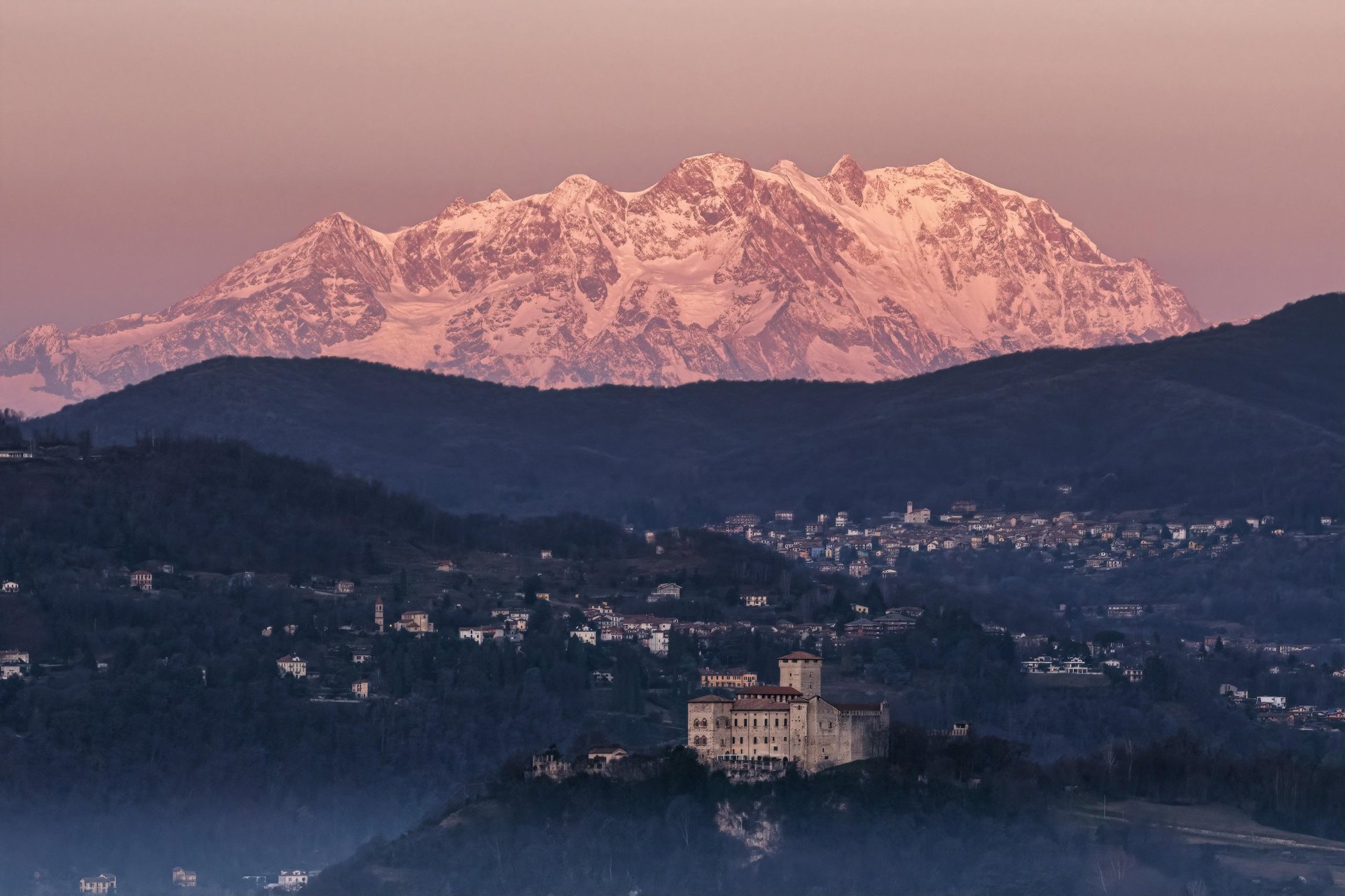 an abstract photo of a curved building with a blue sky in the background