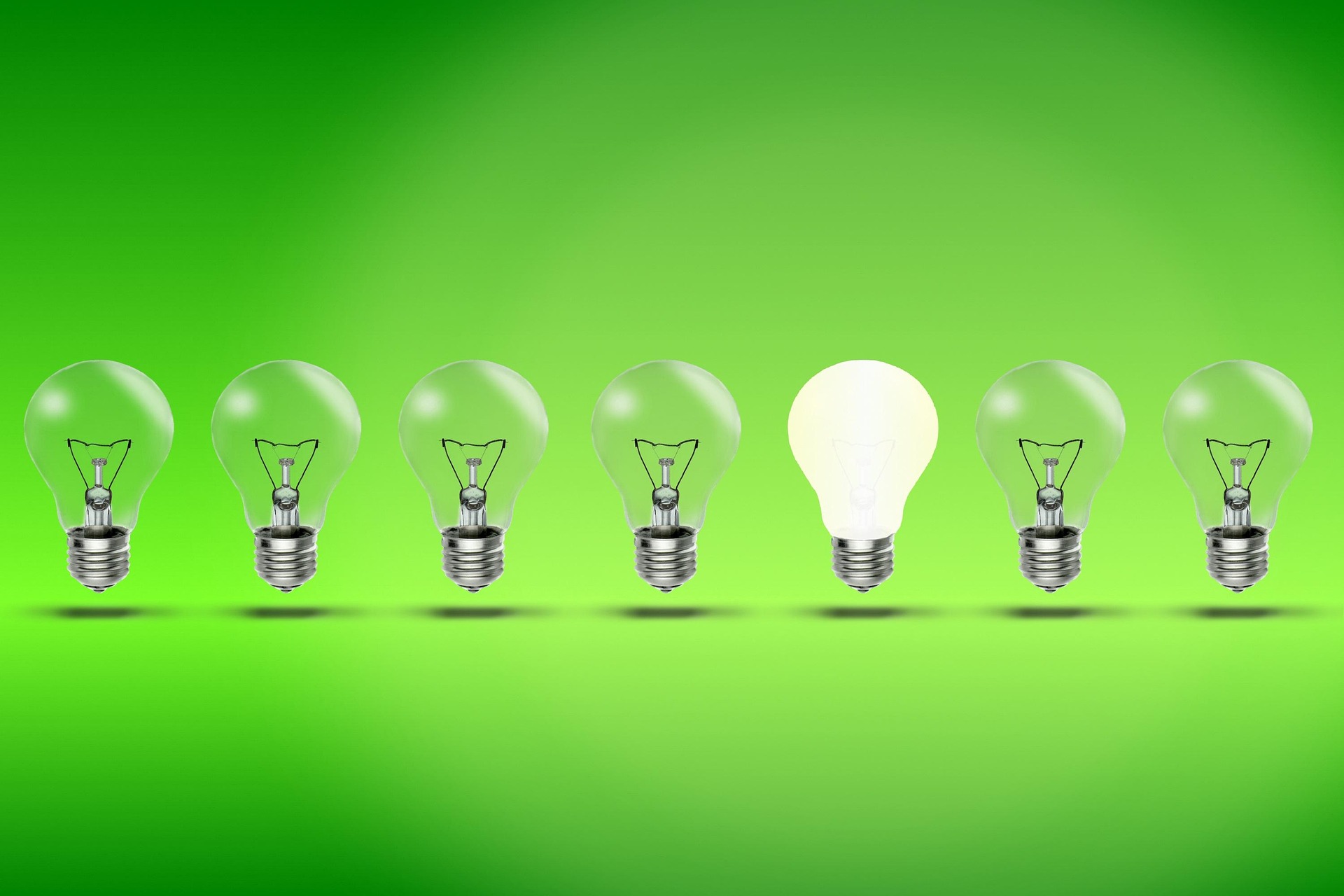 coffee latte near white wireless keyboard and Apple EarPods on the table photography