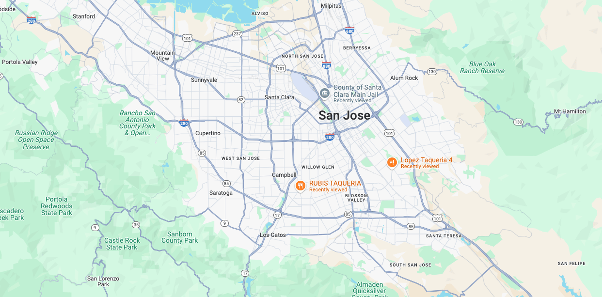 brown and white wooden house near green trees under blue sky during daytime