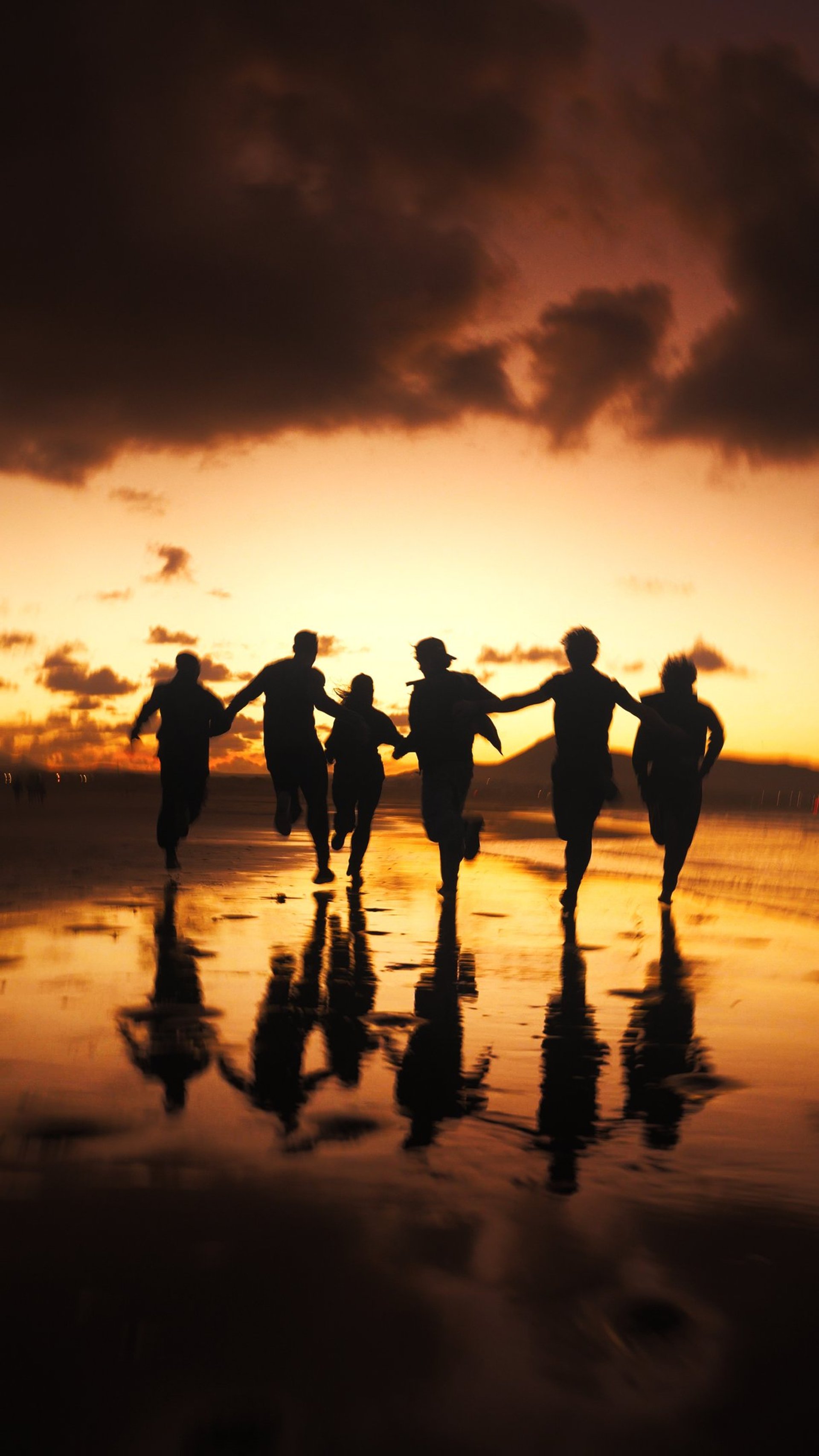 red volkswagen beetle parked on gray asphalt road during daytime