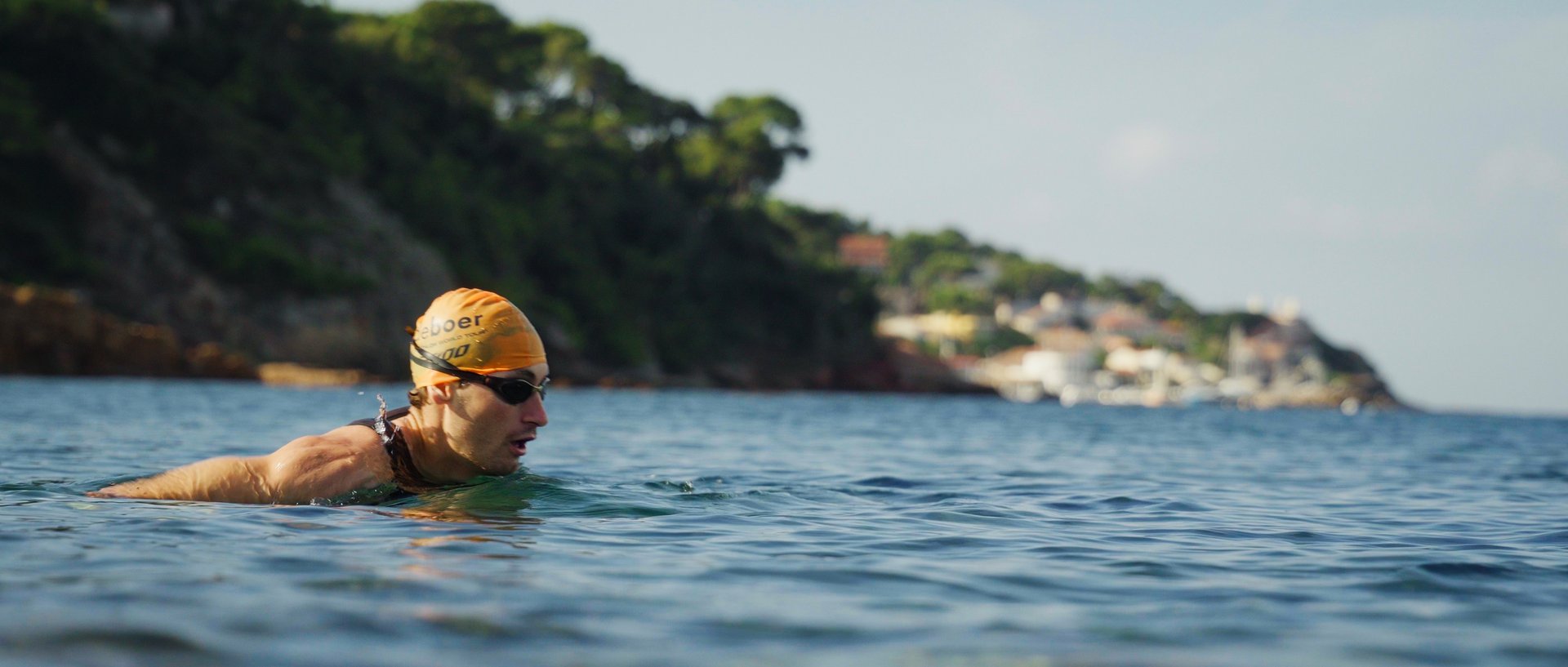 red volkswagen beetle parked on gray asphalt road during daytime