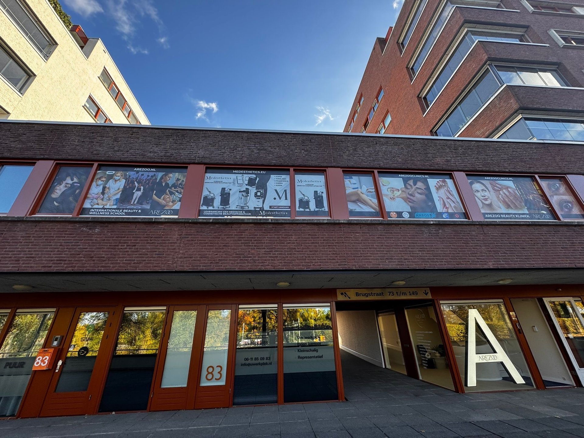 an abstract photo of a curved building with a blue sky in the background