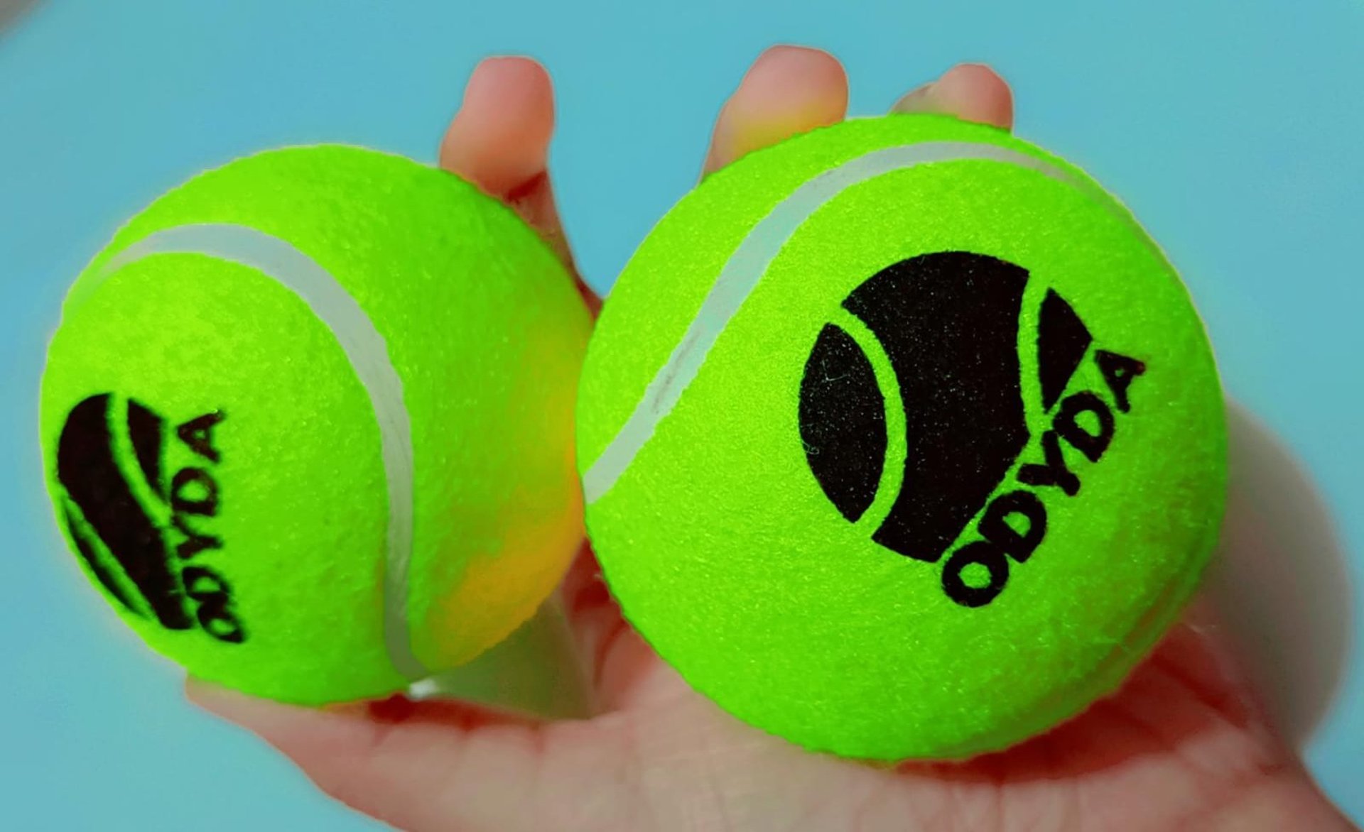 a tennis ball is seen through a hole in a wall