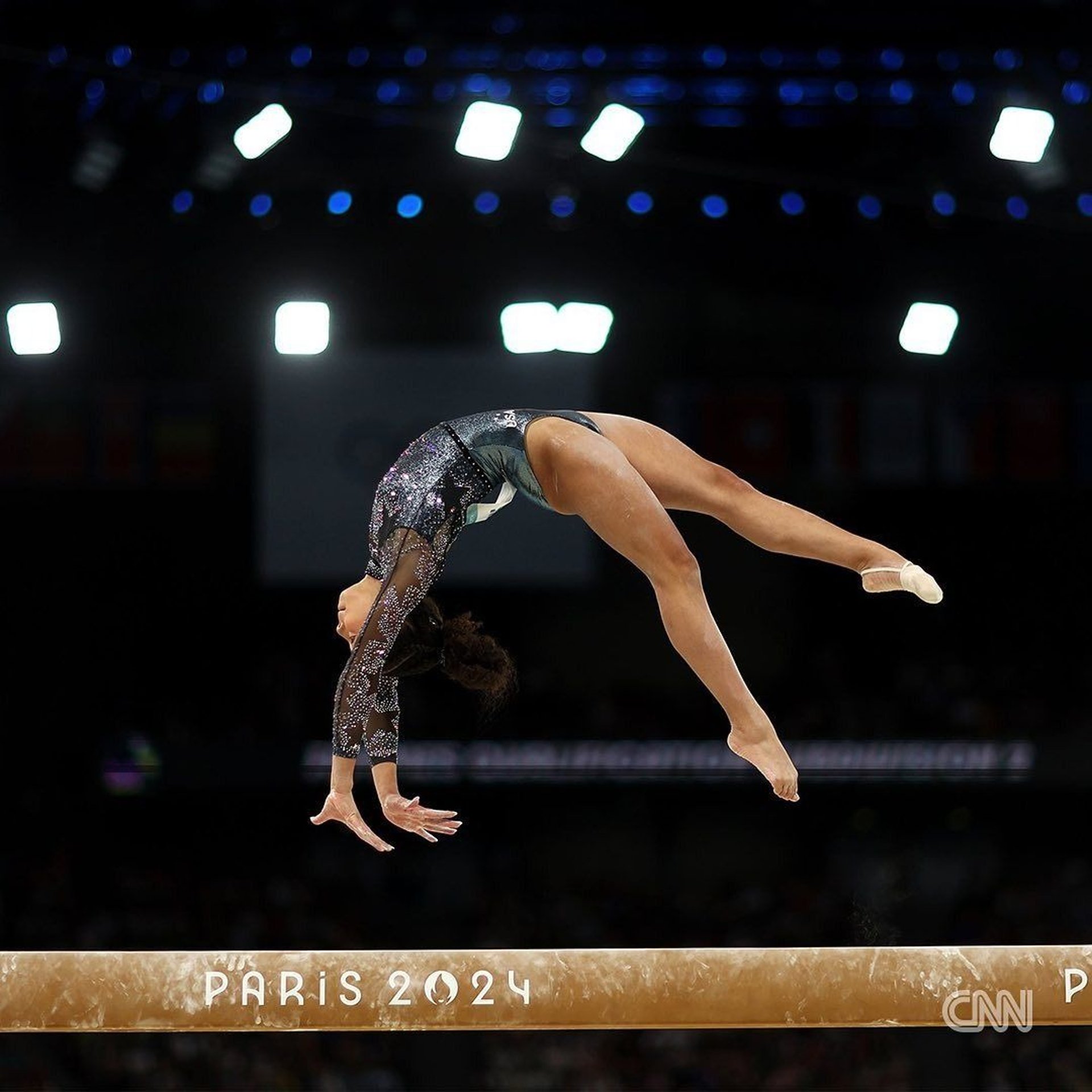 an abstract photo of a curved building with a blue sky in the background