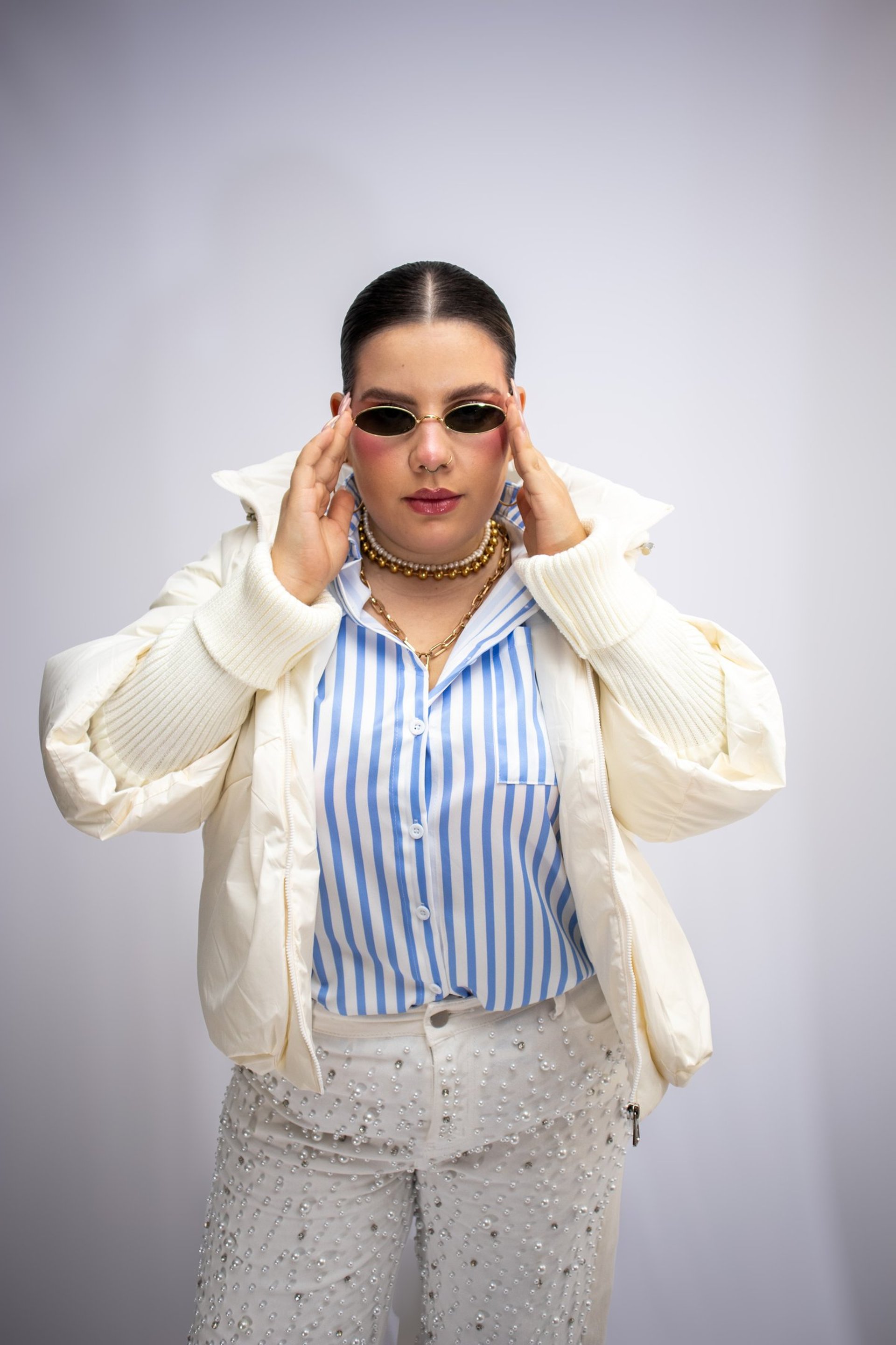 woman wearing yellow long-sleeved dress under white clouds and blue sky during daytime